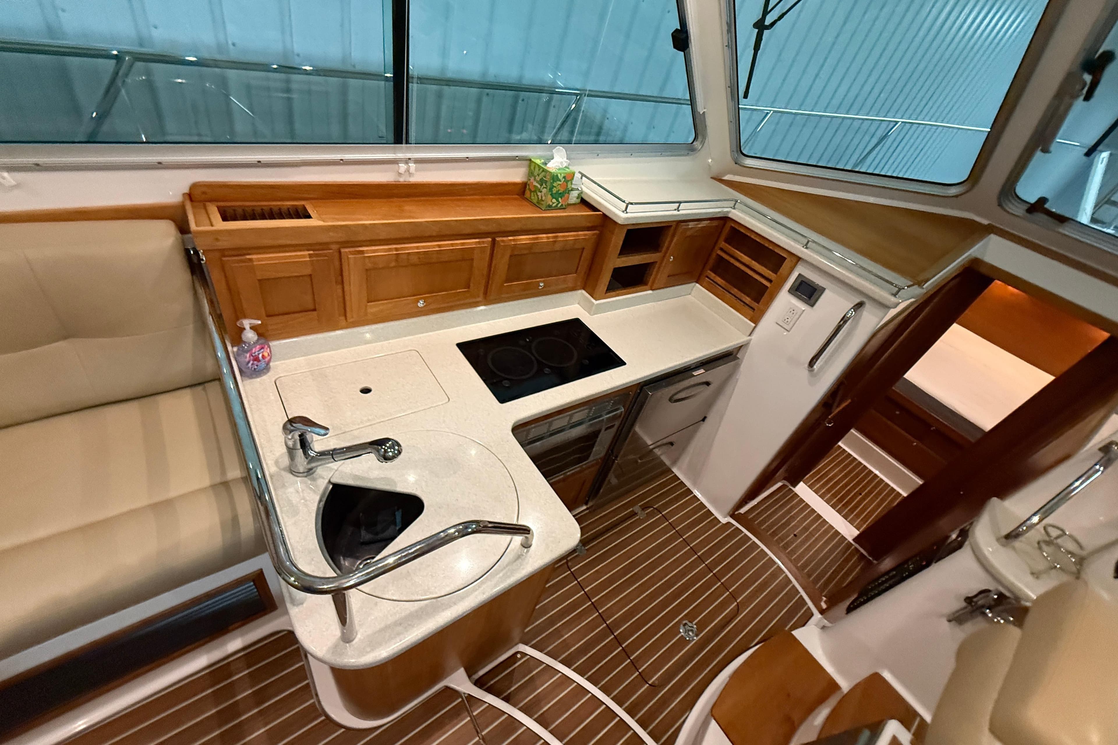 Interior of 2017 Back Cove 37 yacht featuring modern kitchen and wooden cabinetry.