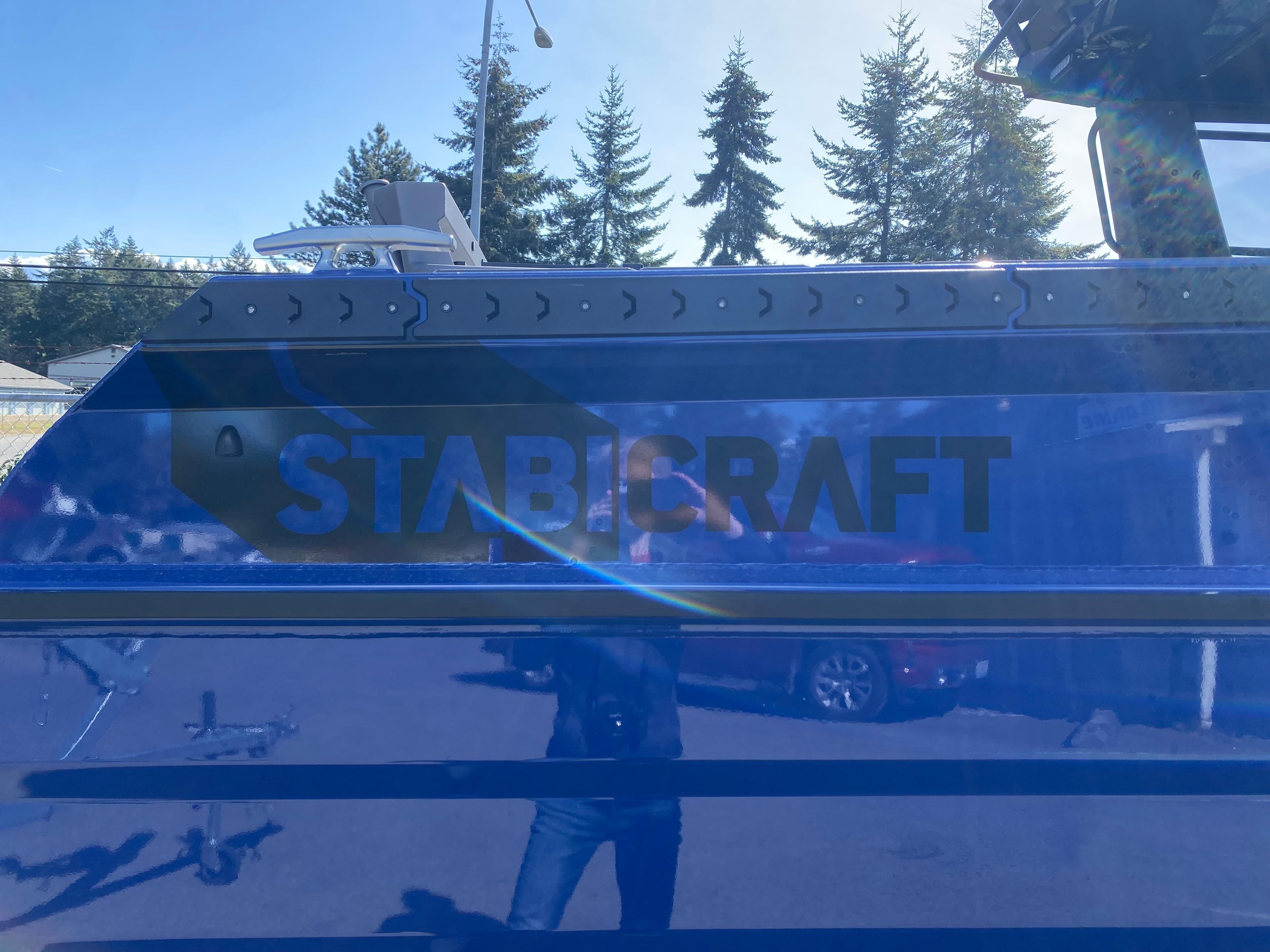 2025 Stabicraft 2350 Supercab boat with reflective blue surface and logo.