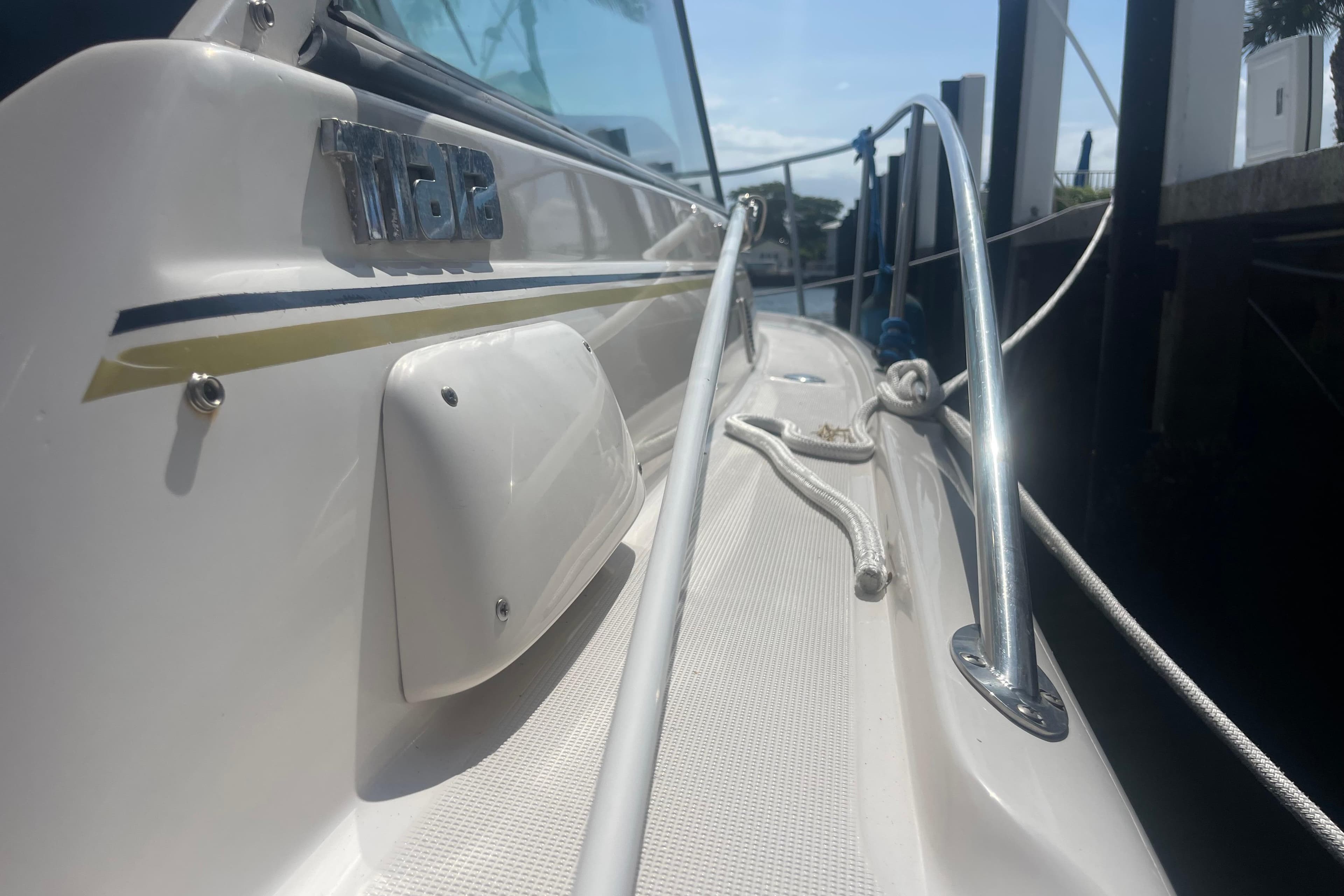 2001 Tiara Yachts 2900 Coronet docked, showcasing sleek design and chrome railings.