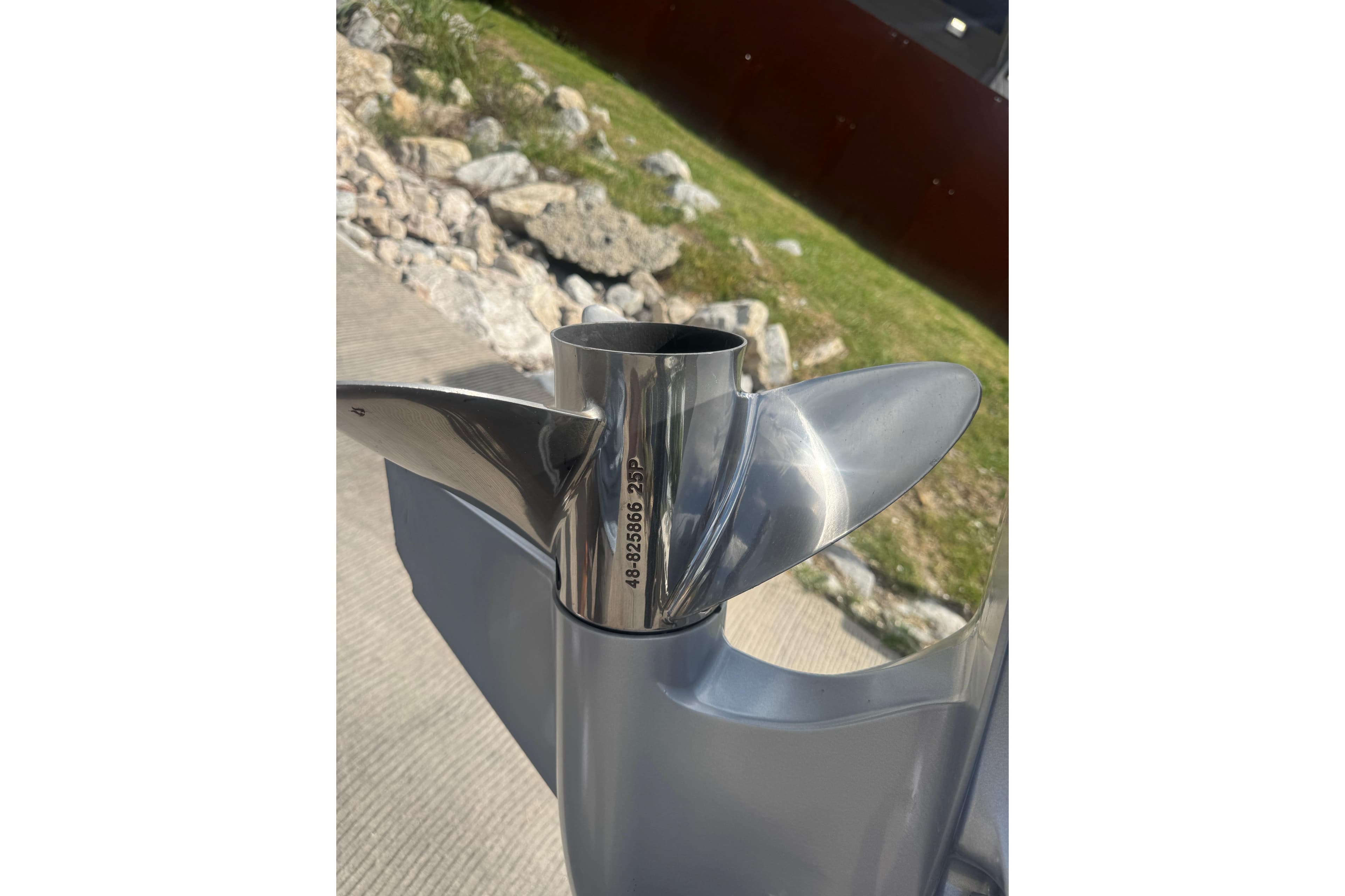 Propeller of 2010 Ranger Z521 Comanche boat, shiny metal finish, outdoors.