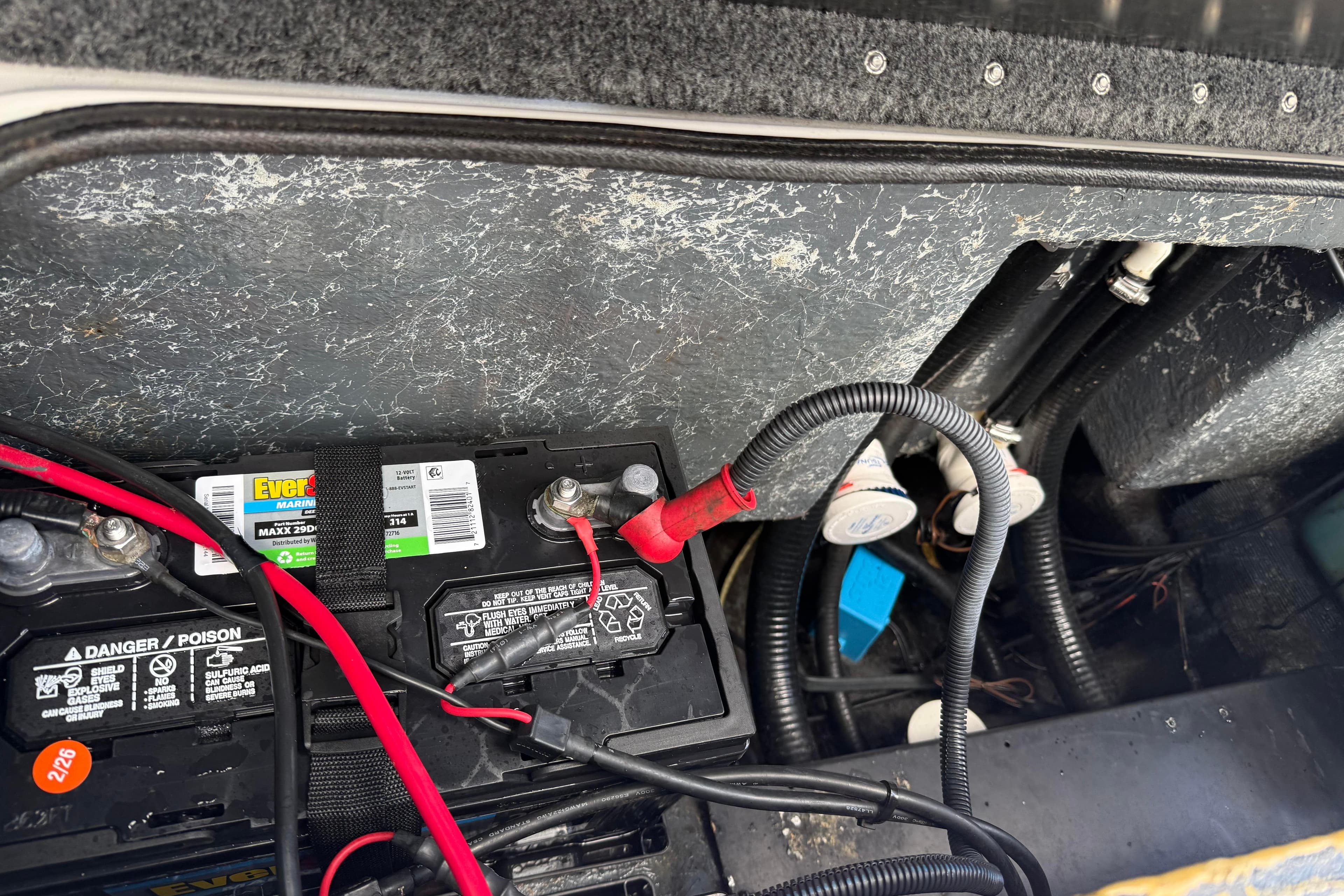 2007 Triton TR-196 boat battery compartment with wiring and connections.