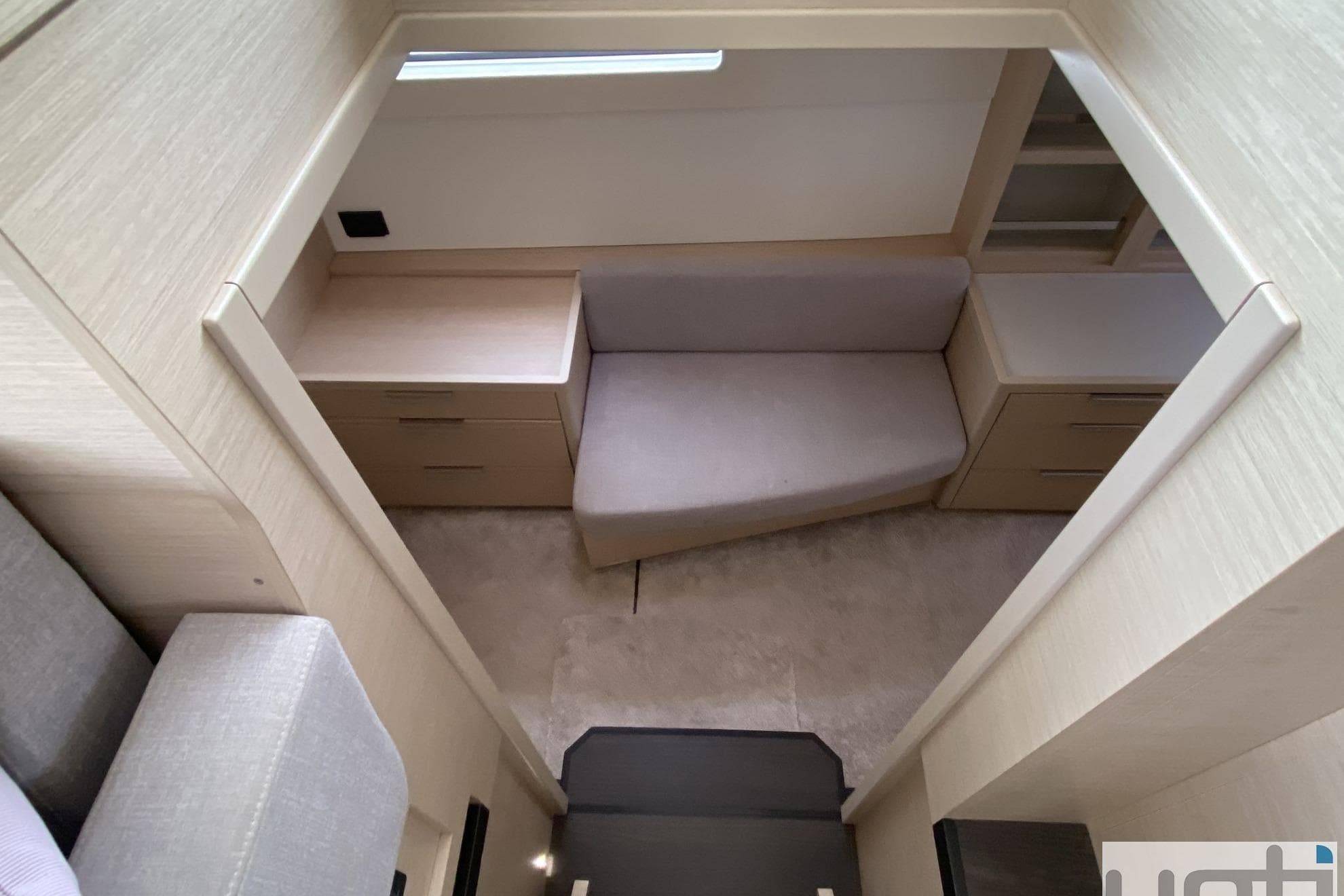 Interior of 2022 Lagoon 46 yacht, featuring modern seating and cabinetry.