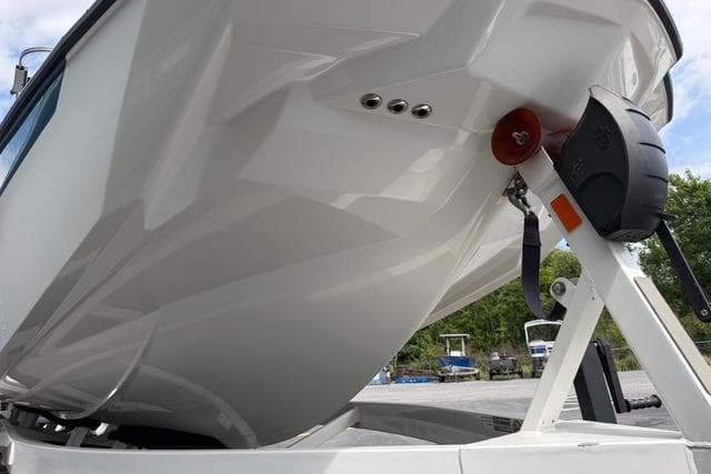 2021 Malibu M240 boat on trailer, showcasing sleek hull design.