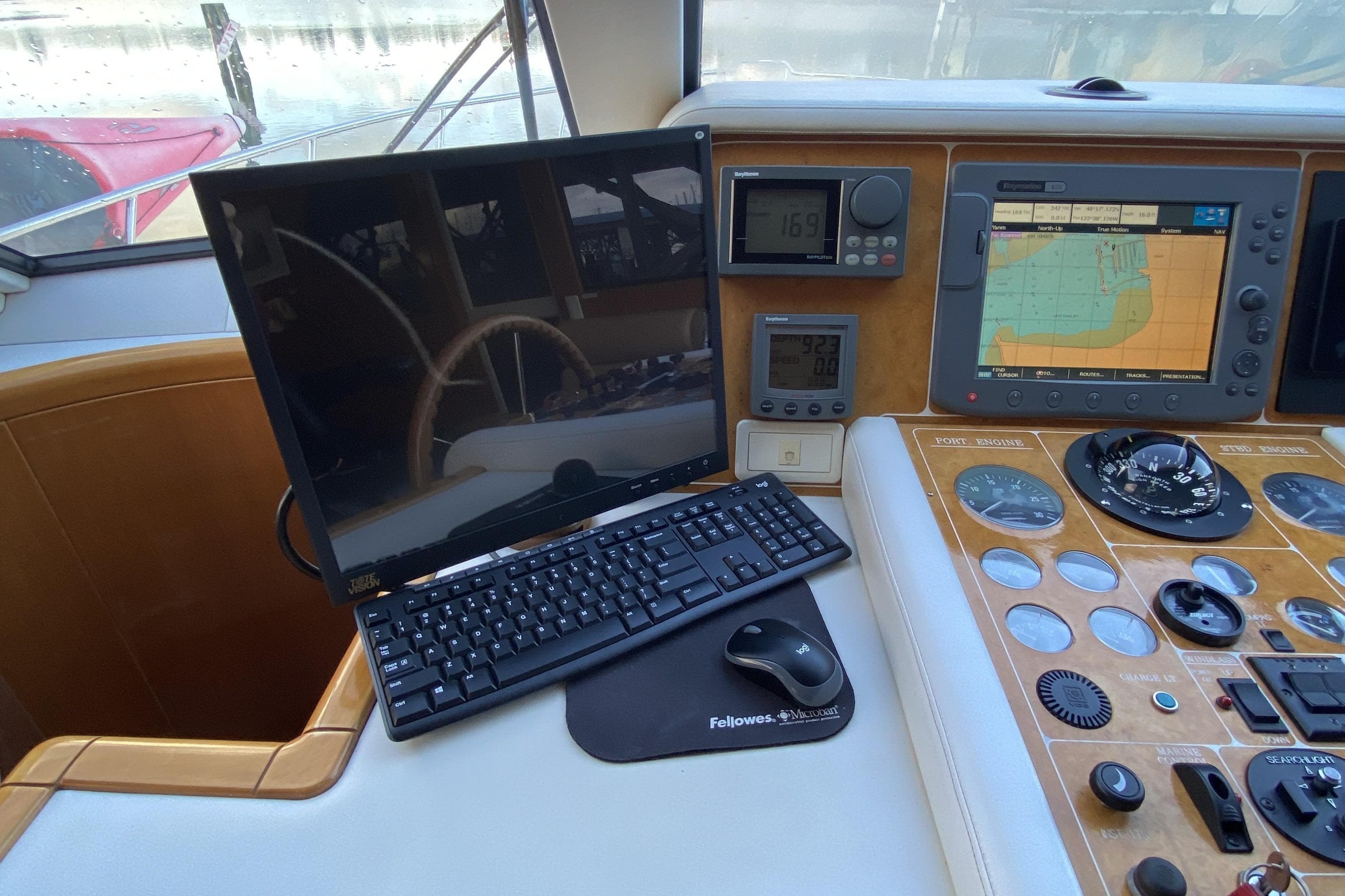 Compass 55 yacht dashboard with navigation screens, keyboard, and control instruments, year 2000 model.