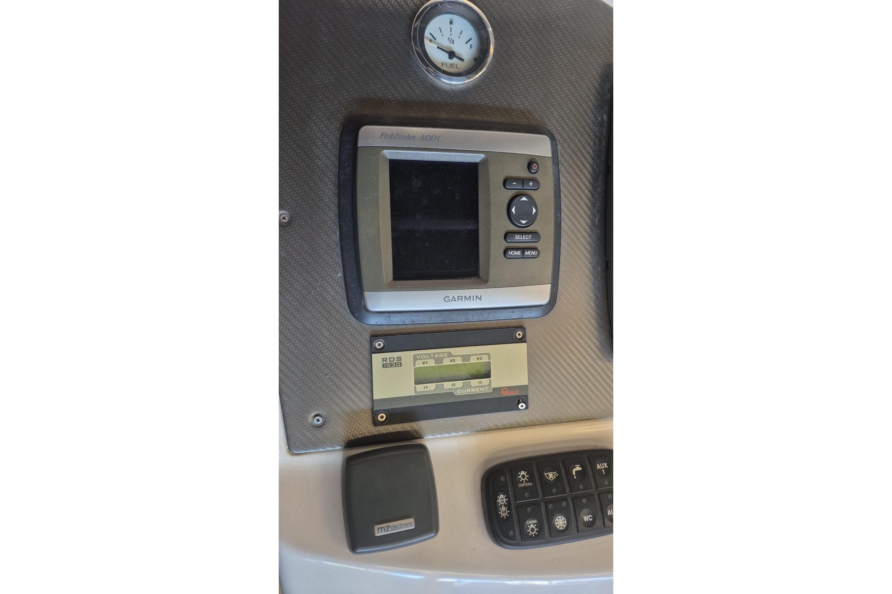 Control panel of a 2010 SACS STRATOS boat with Garmin display and fuel gauge.