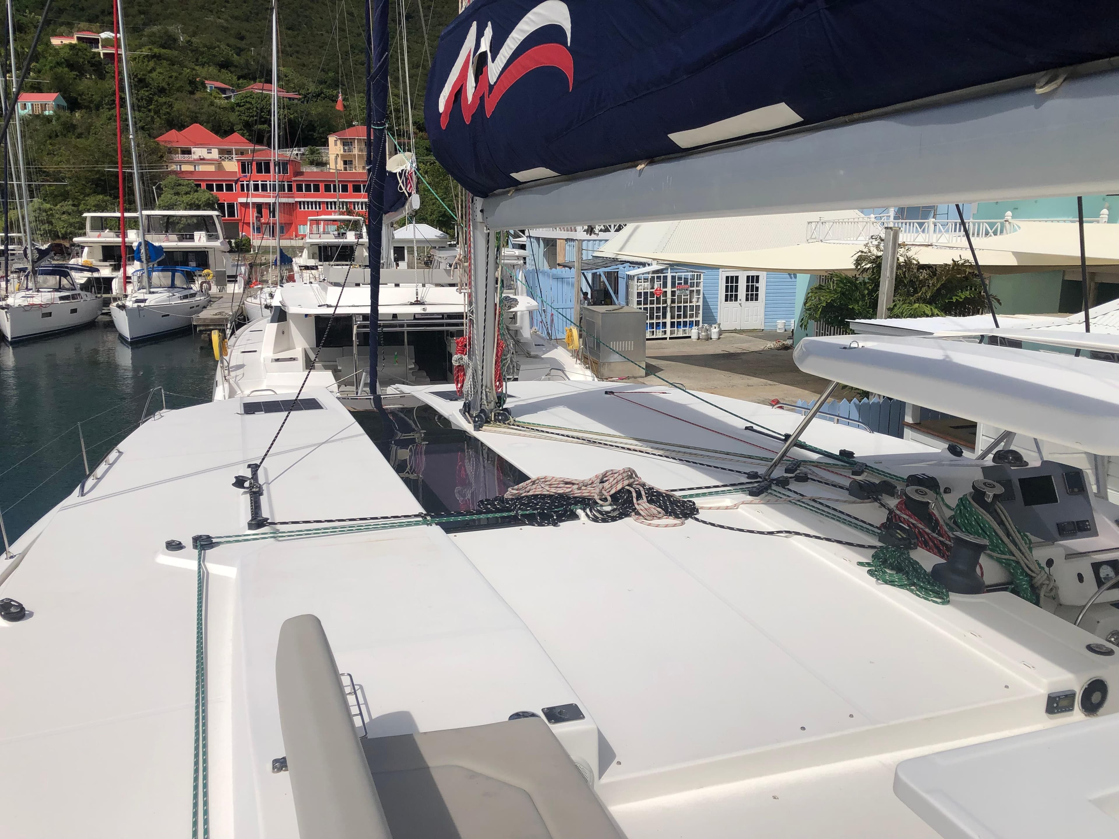 Sailing yacht Leopard 50, 2020 model, docked in a marina with scenic background.