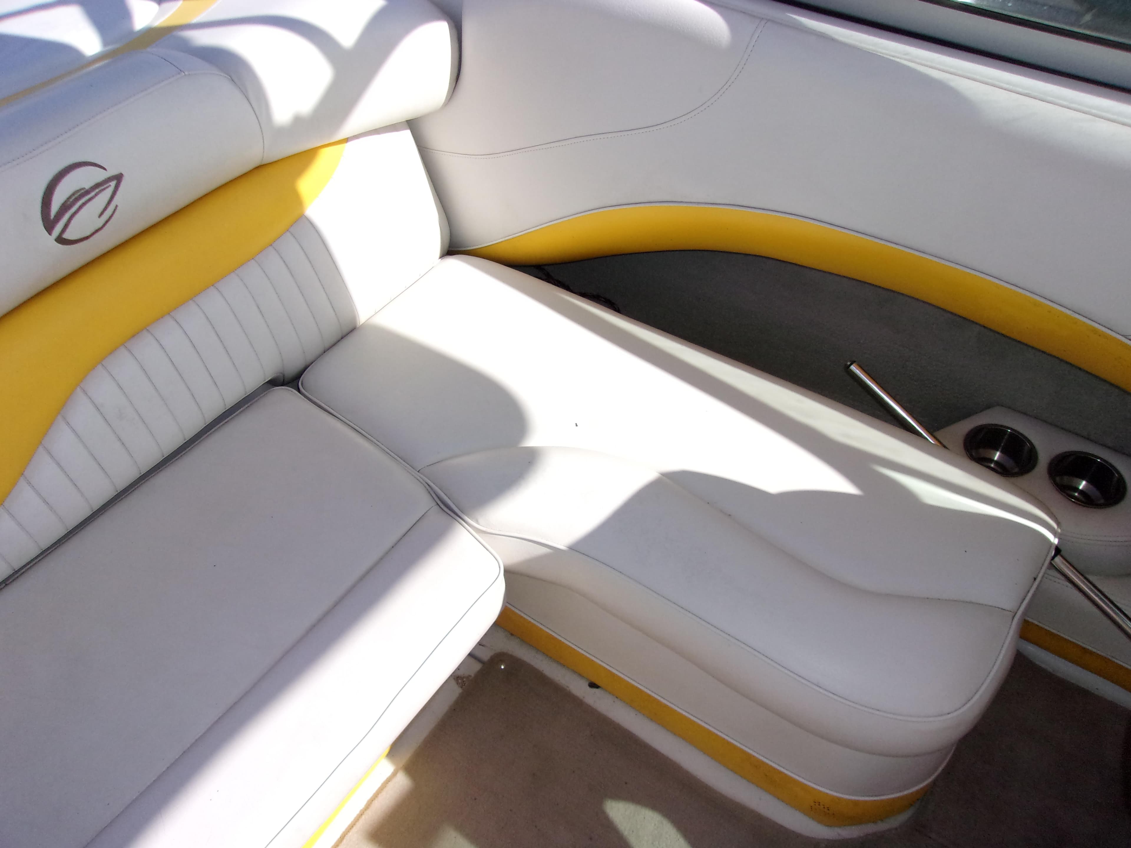 2007 Crownline 23SS boat interior with white and yellow seating, cup holders, and logo detail.