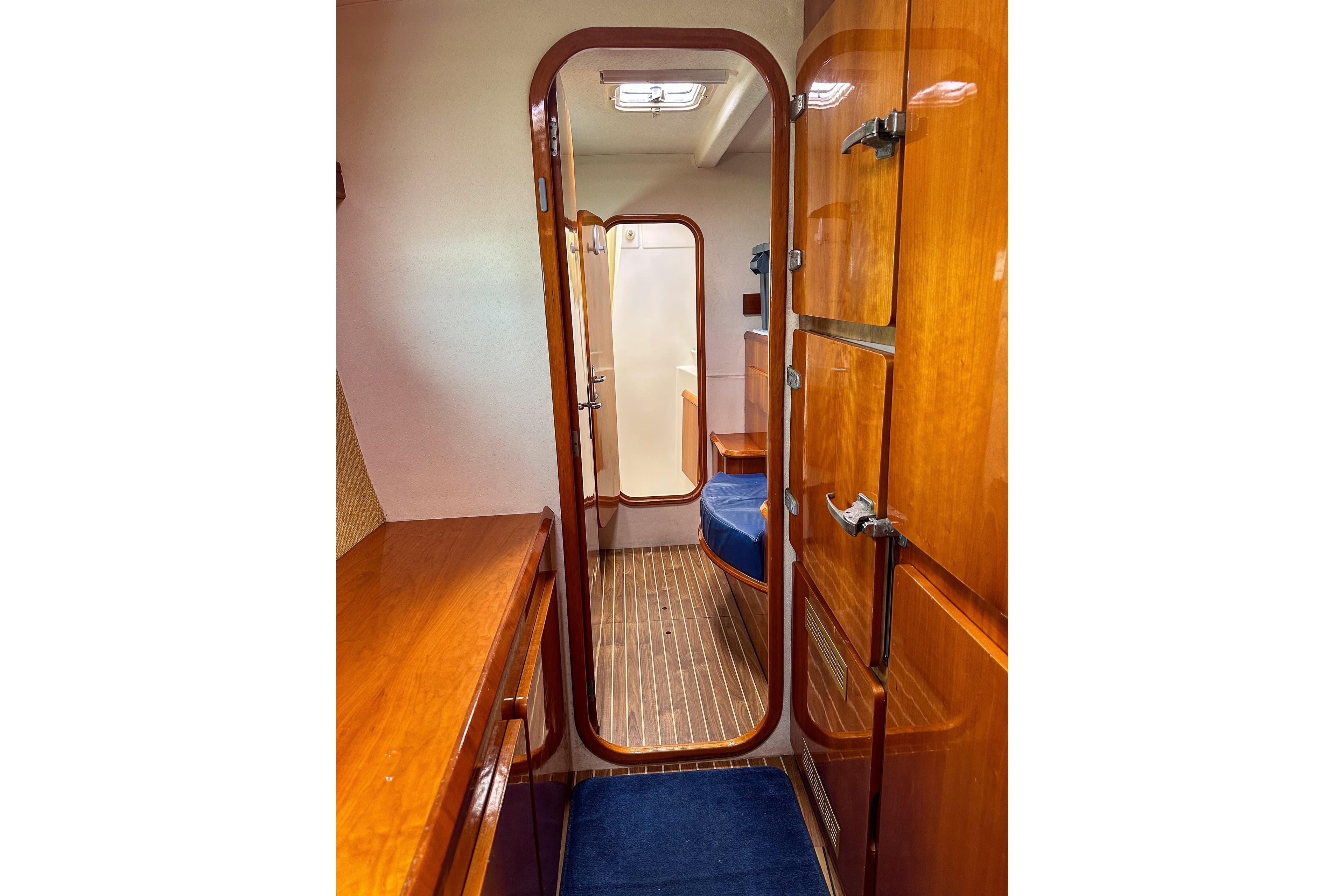 Interior of 2001 Privilege 435 yacht with wooden cabinetry and blue seating.