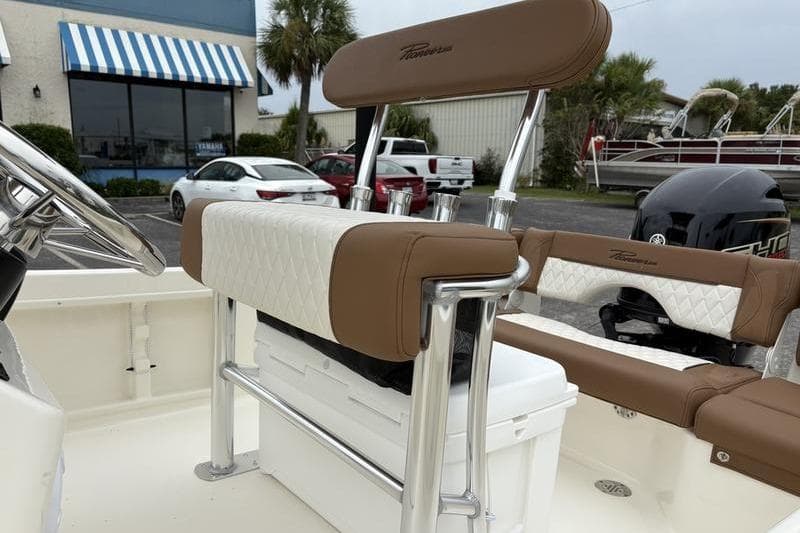 2026 Pioneer Islander 180 boat interior with brown and white seating, chrome accents.