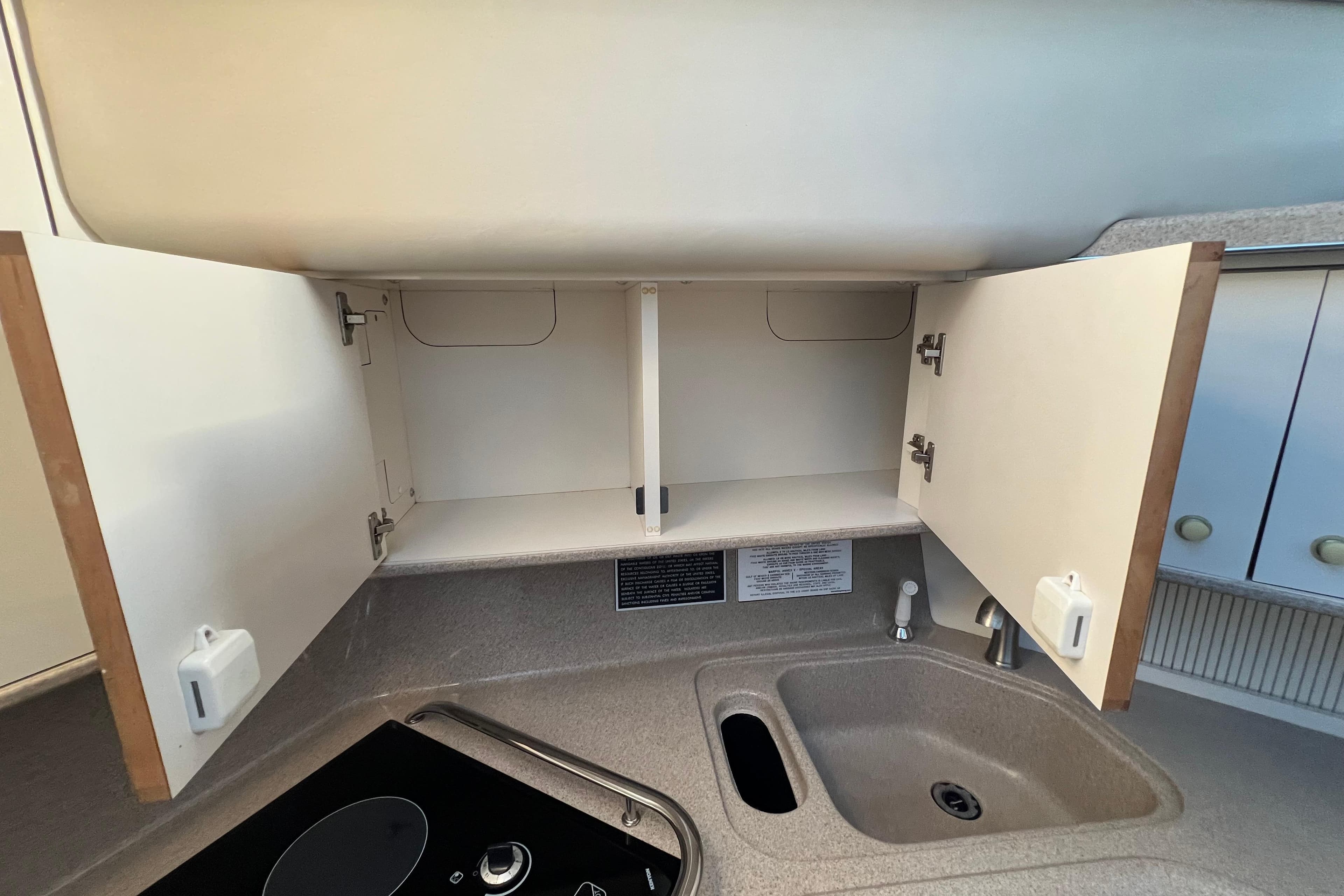 1997 Sea Ray 370 Aft Cabin kitchen with open cabinets and sink.