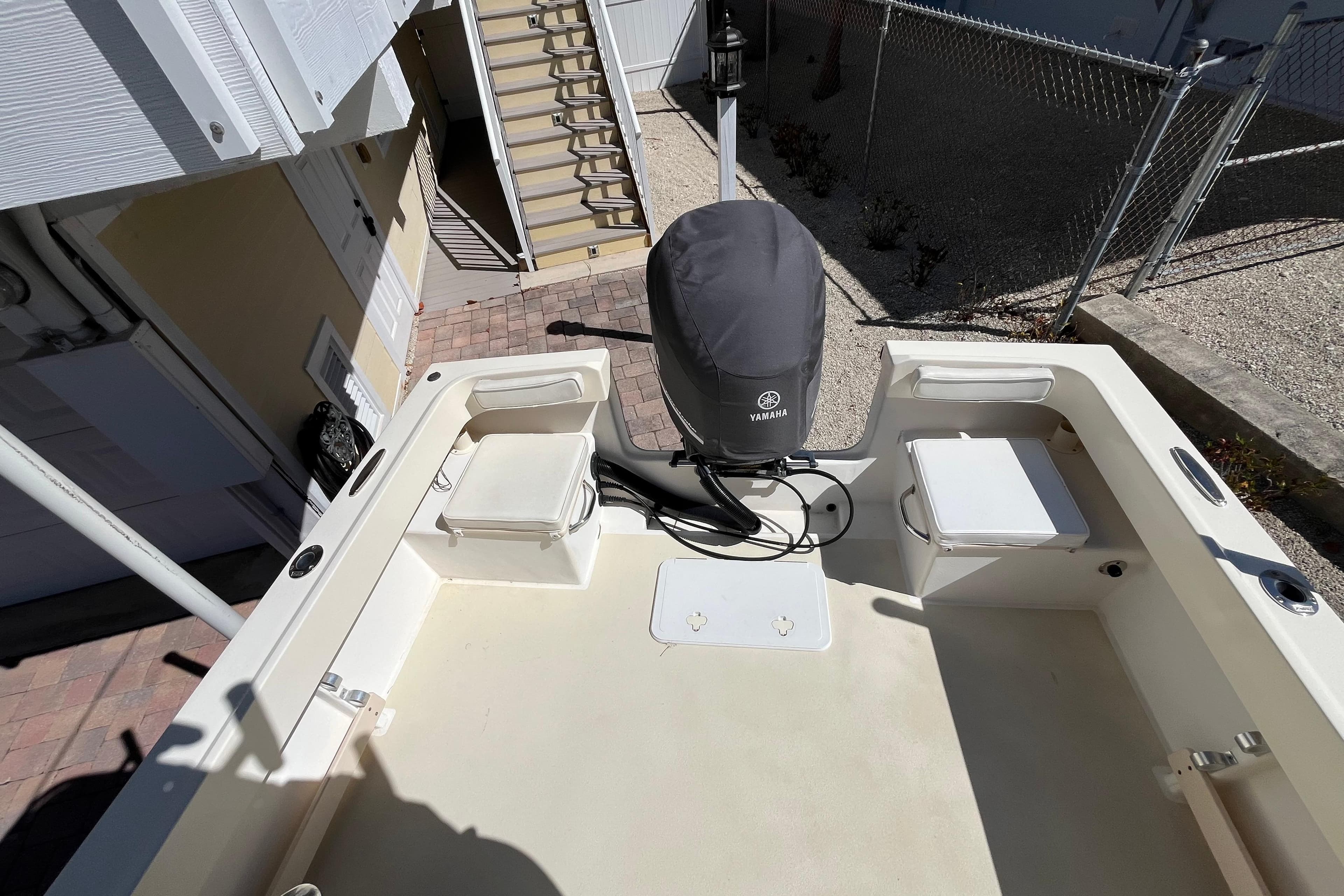 2009 Parker 2300 Special Edition boat with Yamaha engine, docked near stairs.