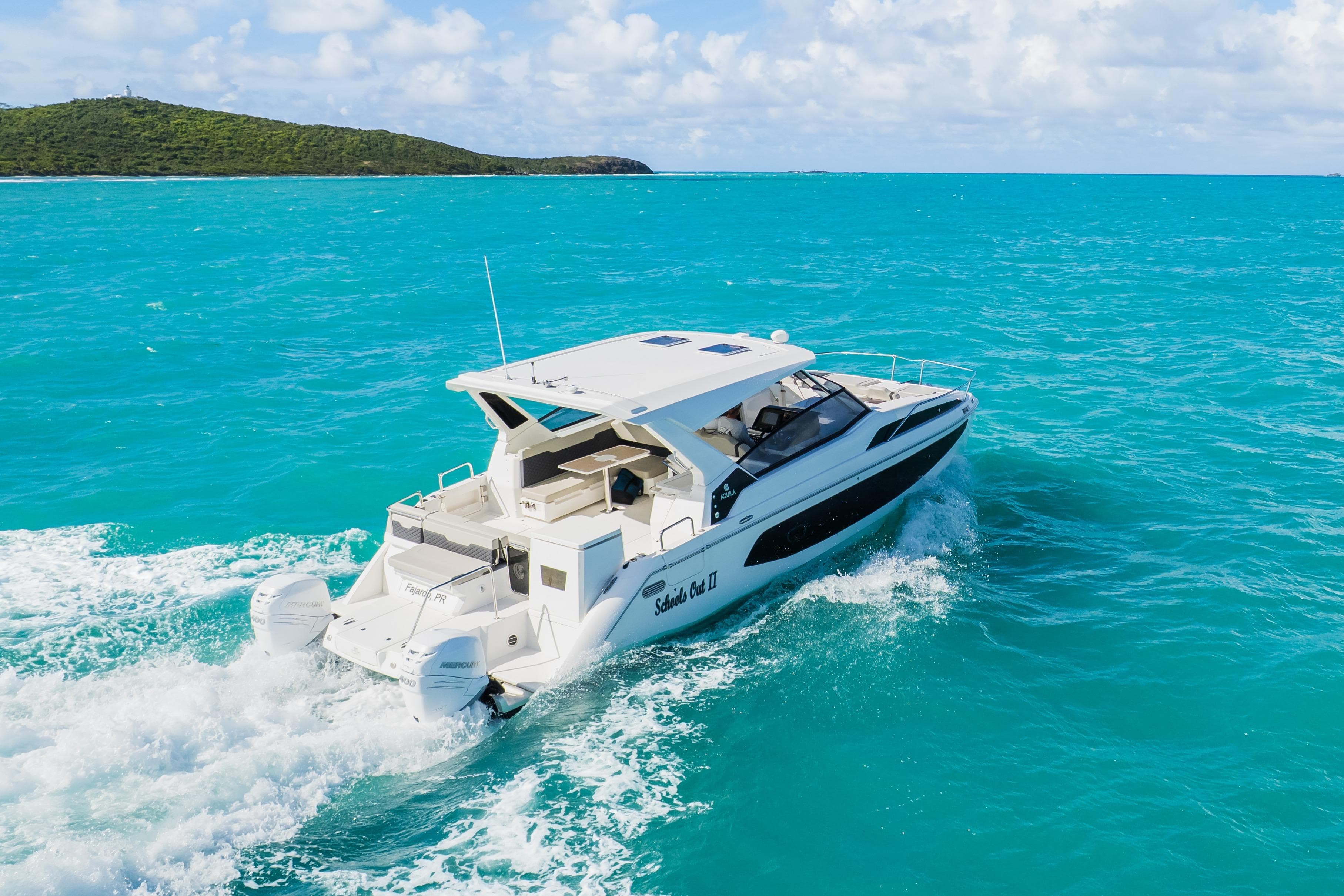 2023 Aquila 36 Sport cruising on turquoise ocean waters.