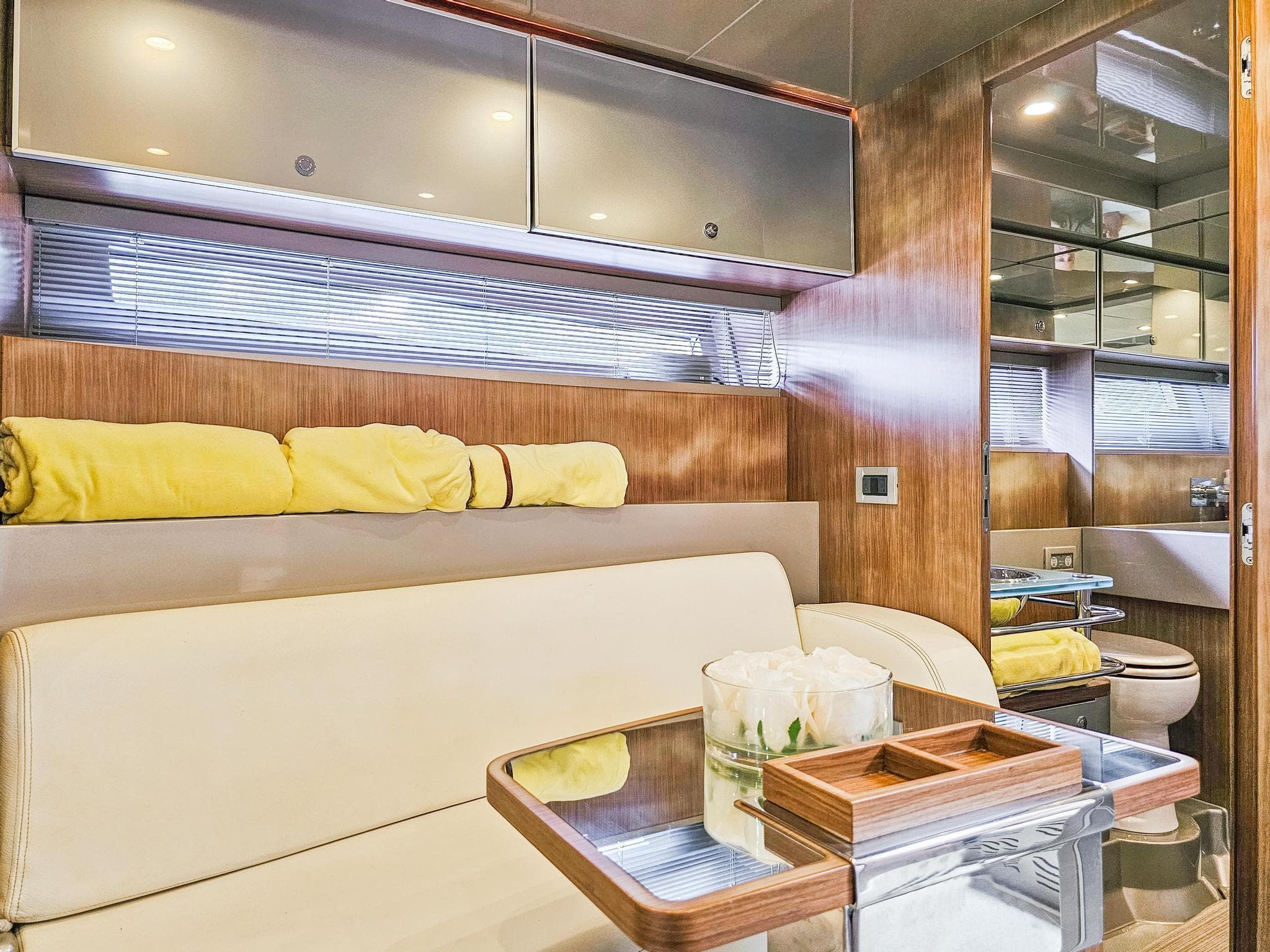 Interior of 2010 Riva Rama yacht with modern furnishings and wooden accents.