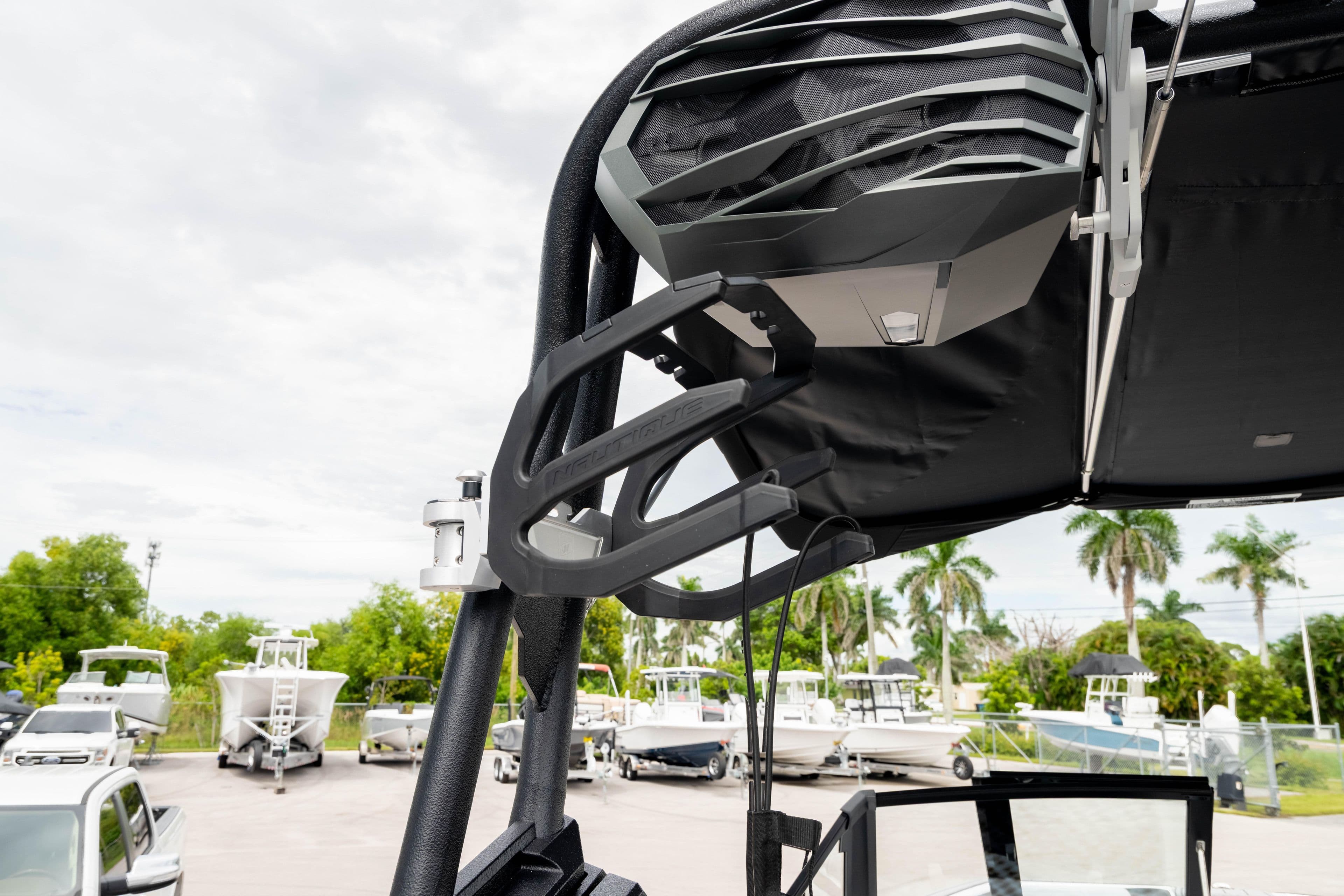 2026 Nautique Super Air Nautique GS22 boat tower with speaker, docked with other boats.