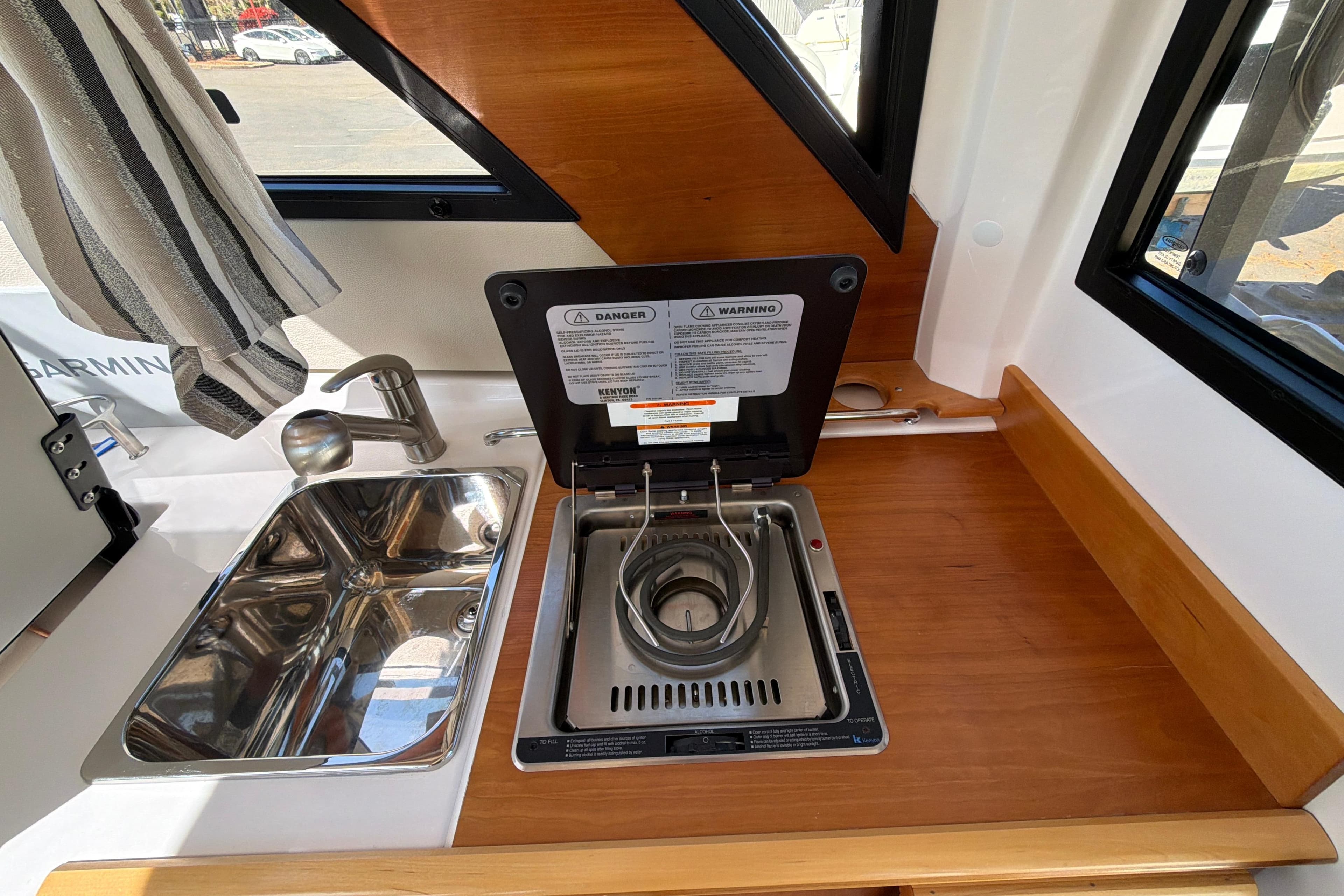 2023 Cutwater C-248 Coupe interior kitchen with sink and stove.