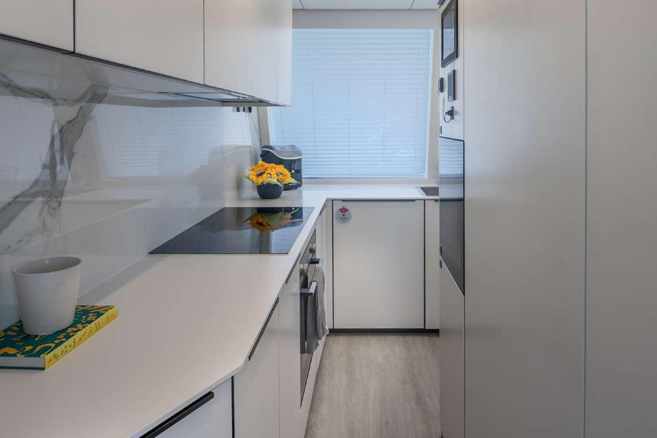 Modern kitchen interior on 2021 Sunreef Supreme 68 Power yacht, featuring sleek design and appliances.