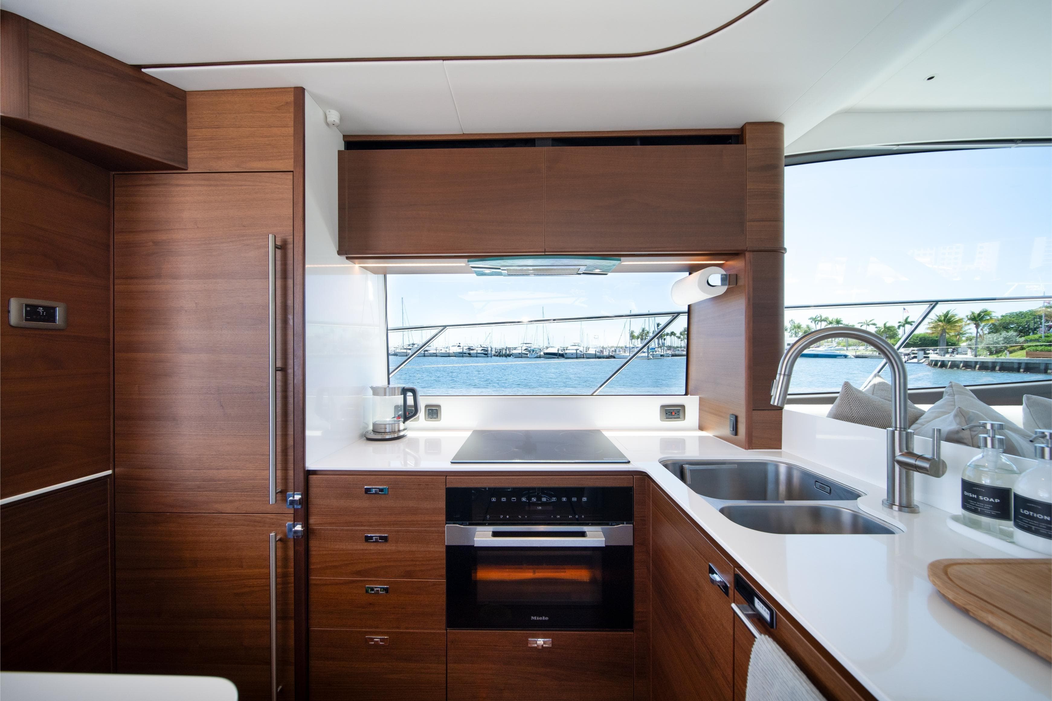 Luxurious kitchen interior of 2025 Princess F65 yacht with modern appliances and ocean view.