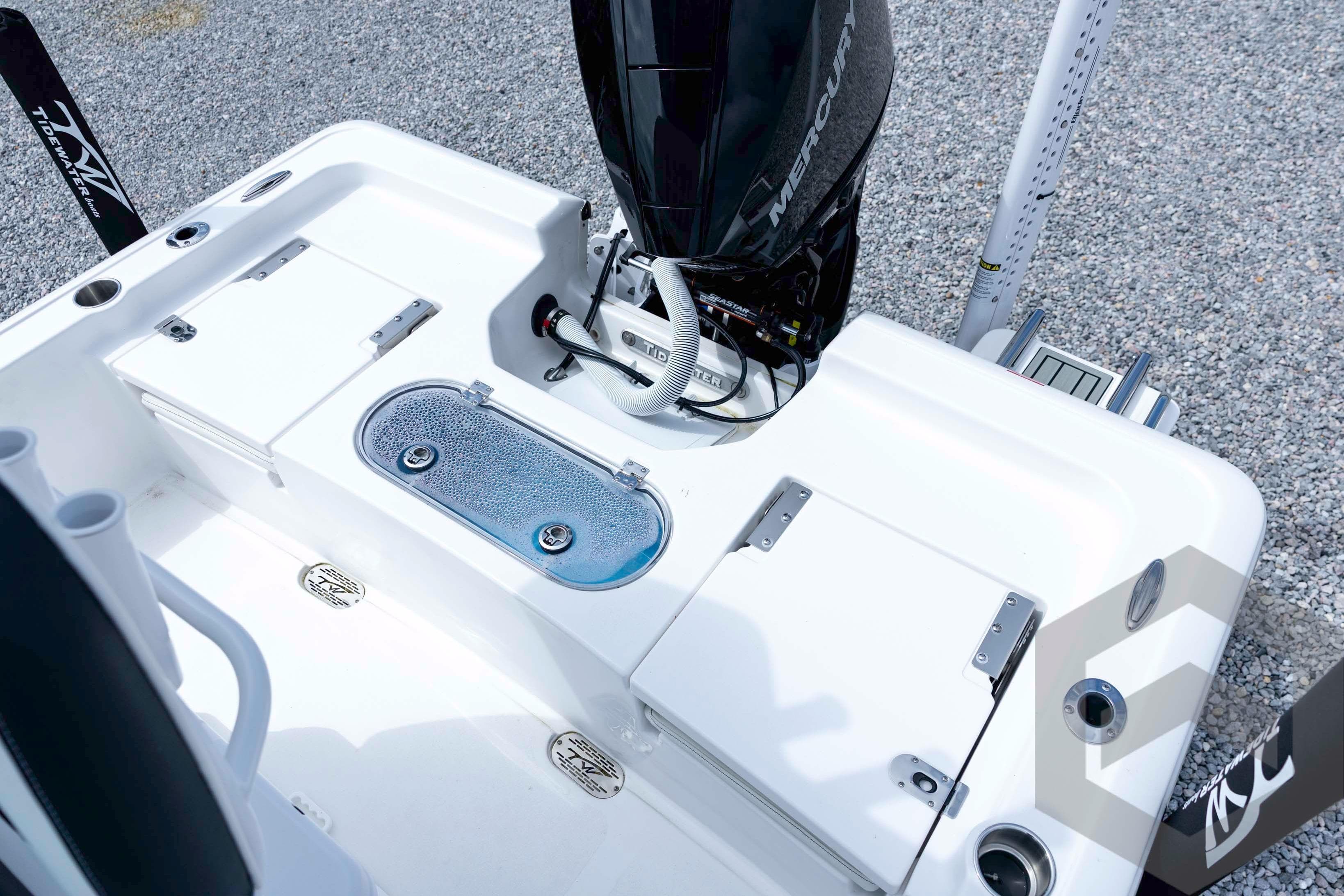 2026 Tidewater 2110 Bay Max boat deck with Mercury engine and storage compartments.