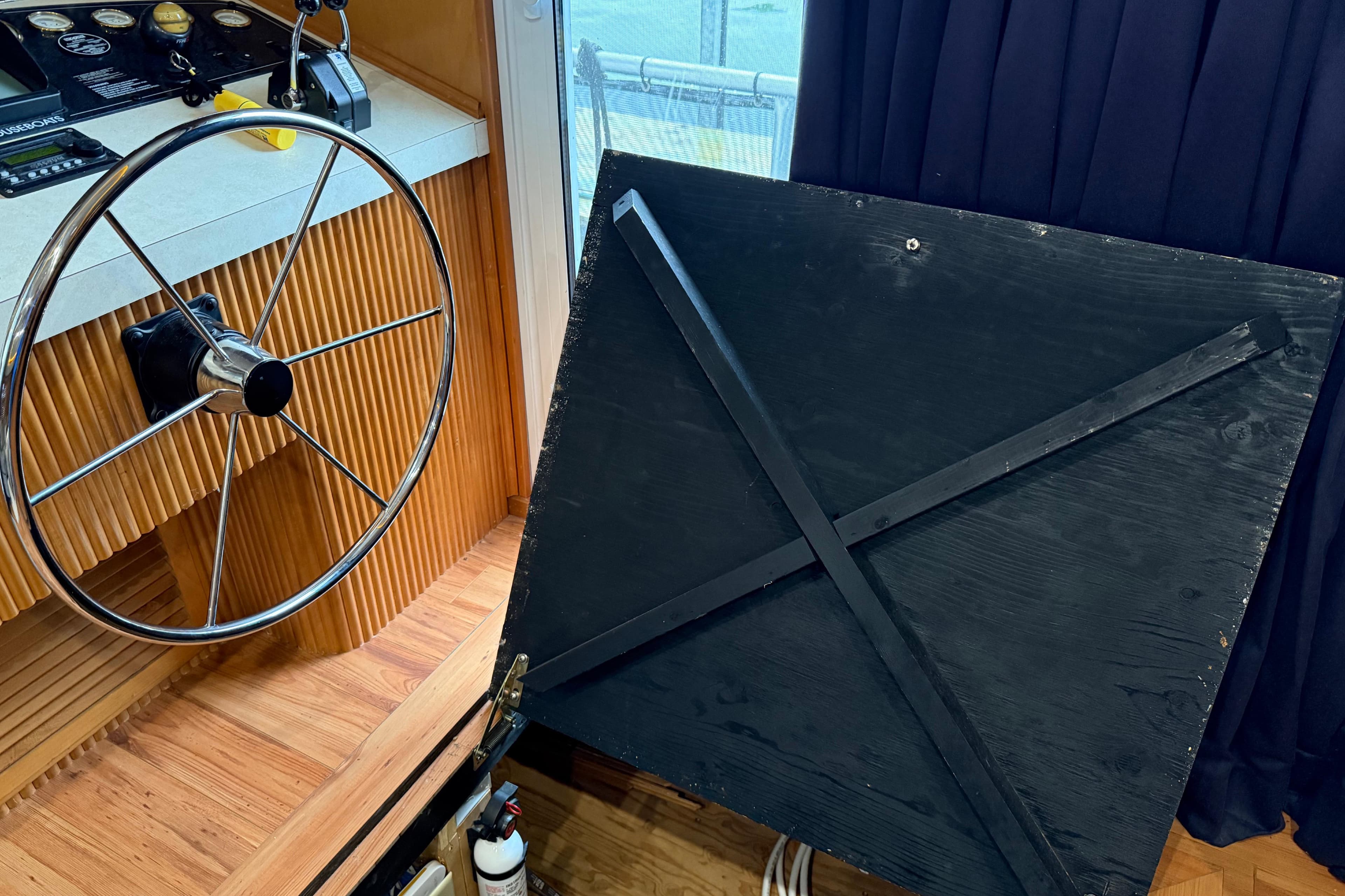 Steering wheel and control panel of 2001 Sharpe 80 X 18 boat interior.
