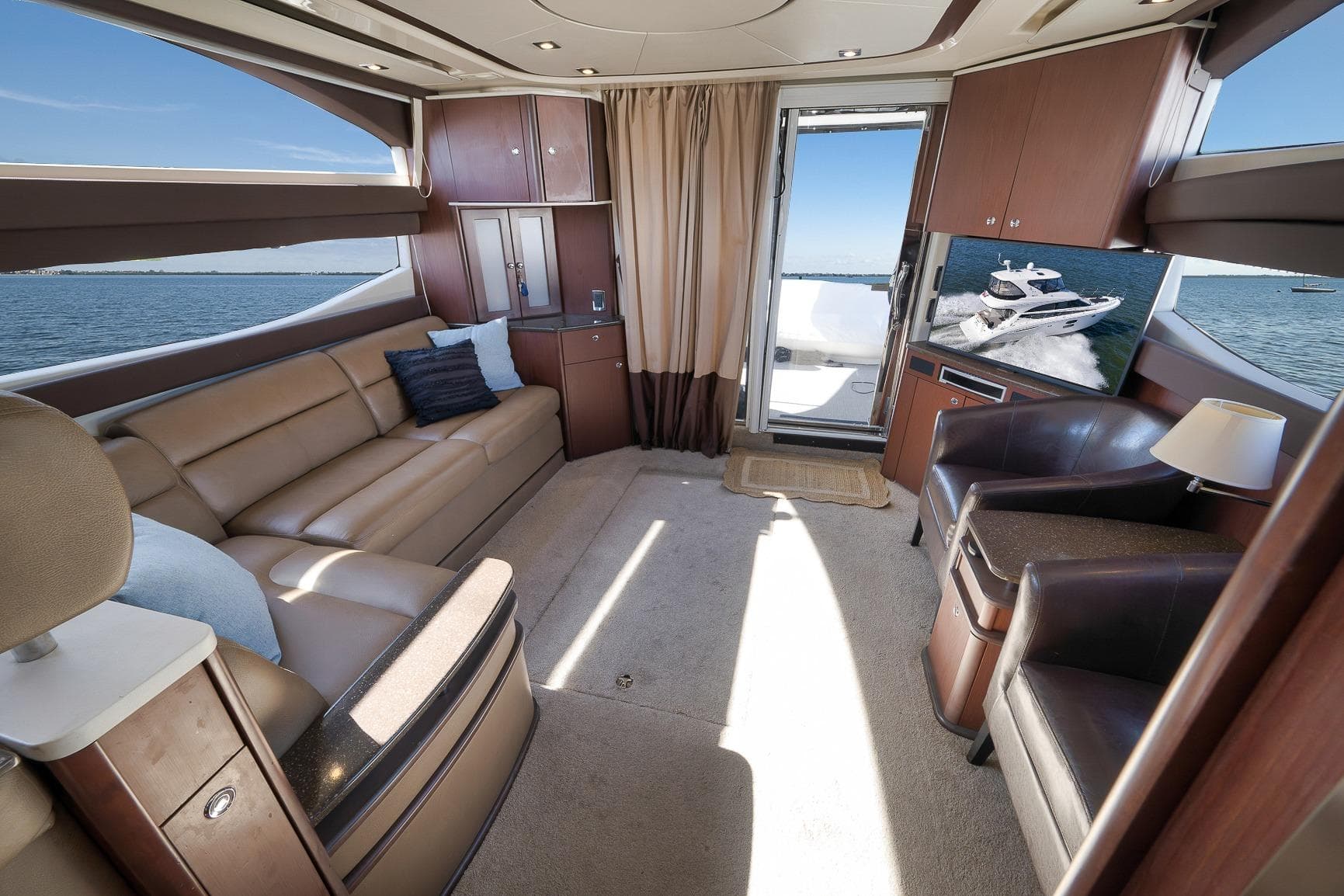 Luxurious interior of 2012 Meridian 441 Sedan yacht with leather seating and ocean view.