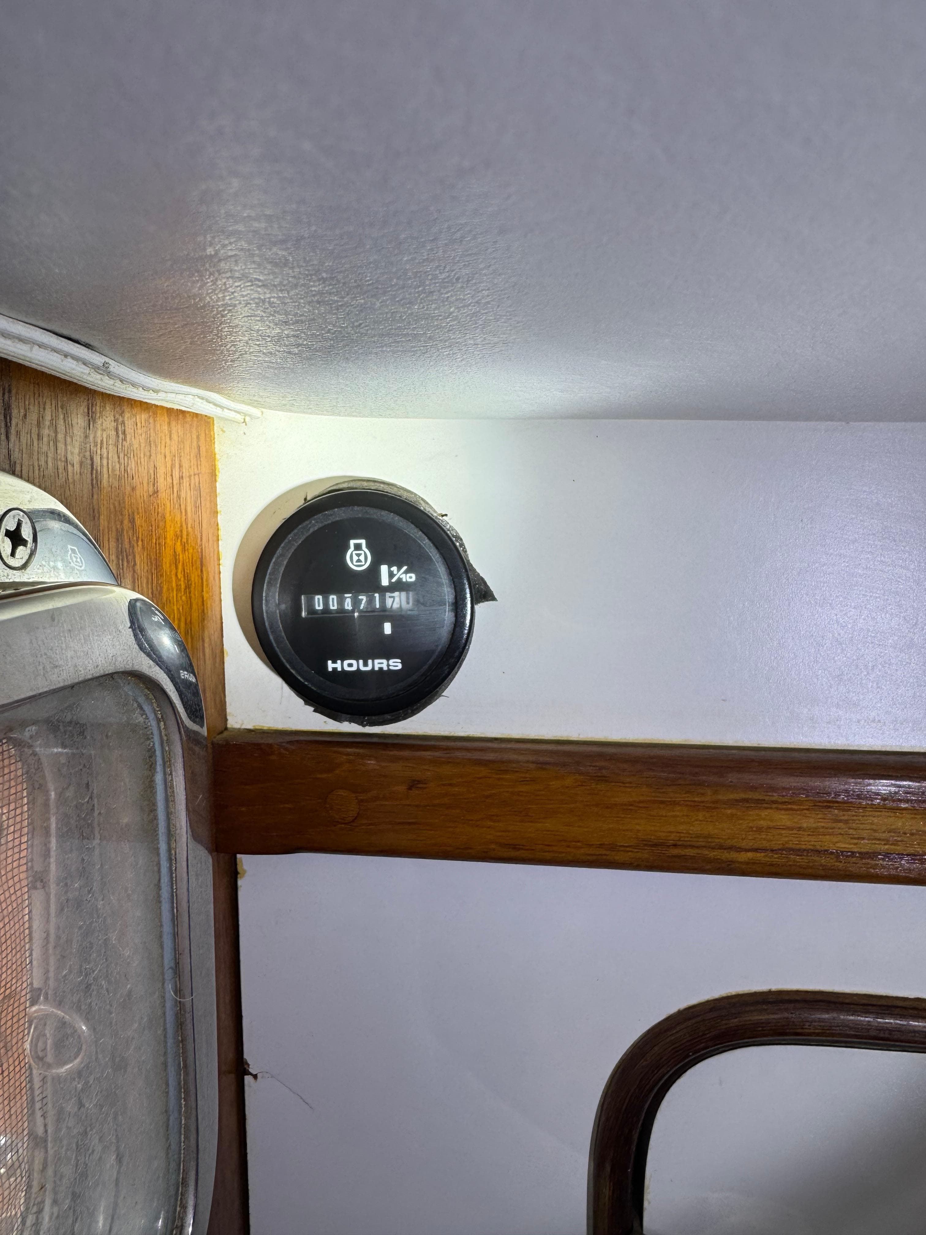Hour meter on 1981 Gulfstar 44 boat interior, mounted on wooden panel.