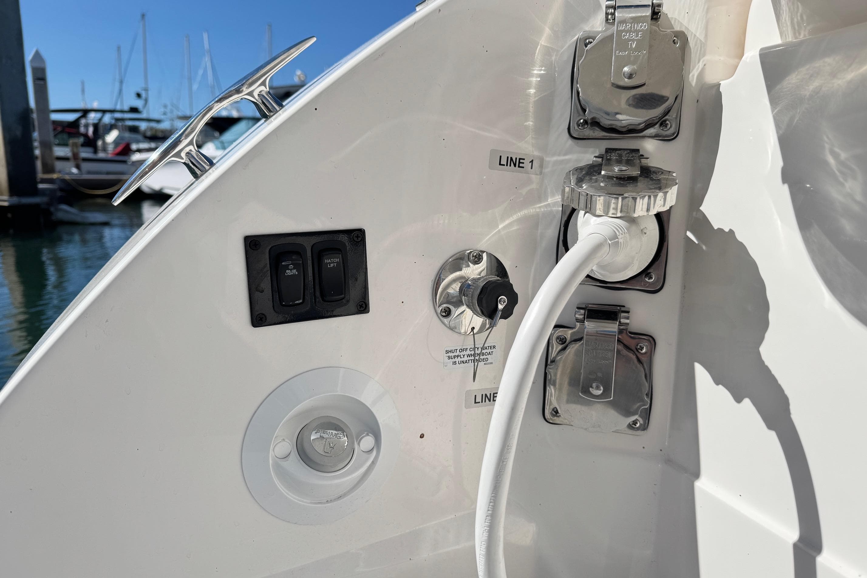 2026 Regal 33 XO boat utility connections and controls at marina dock.