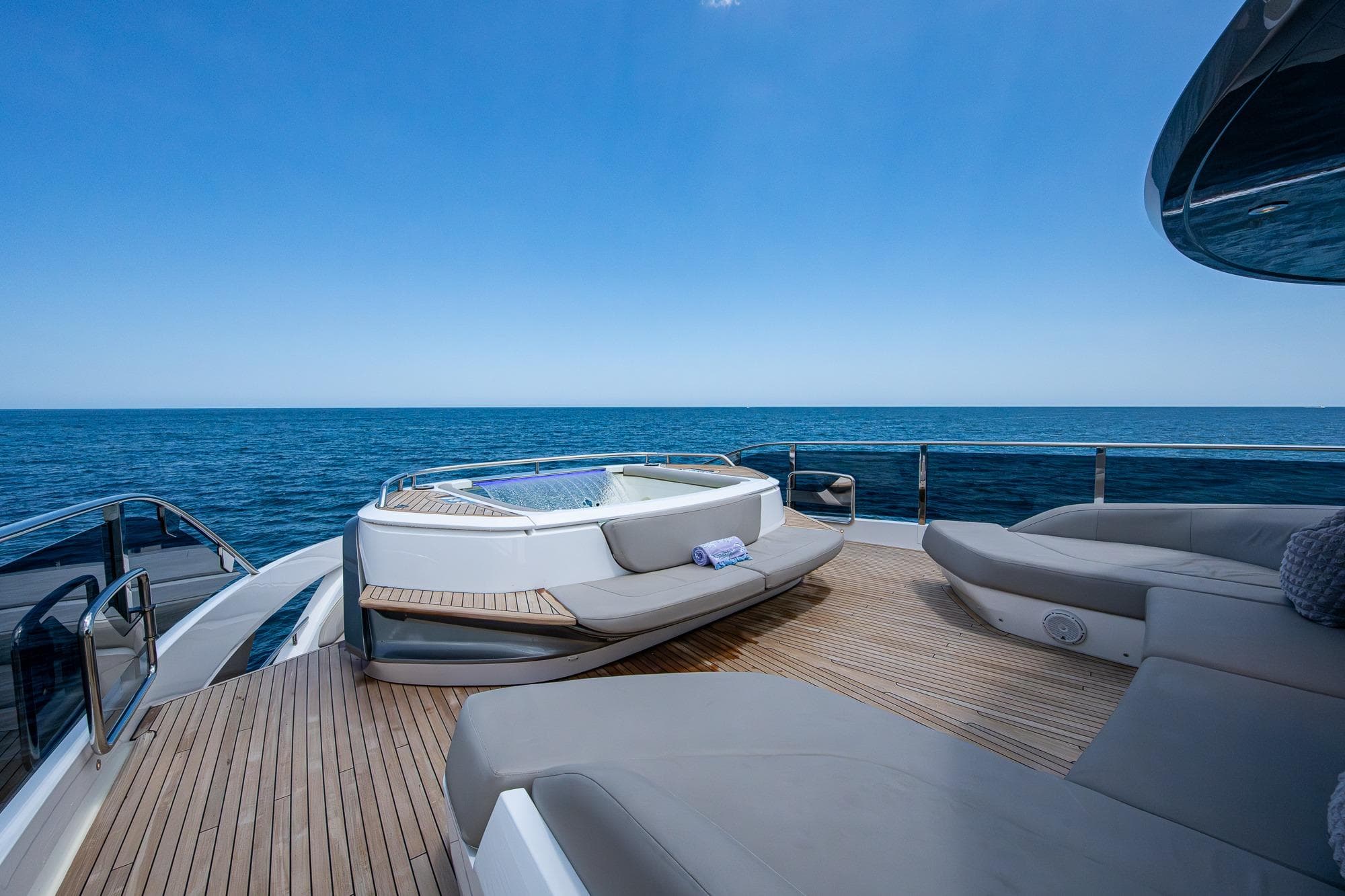 Luxurious 2022 Princess X95 yacht deck with jacuzzi and ocean view.