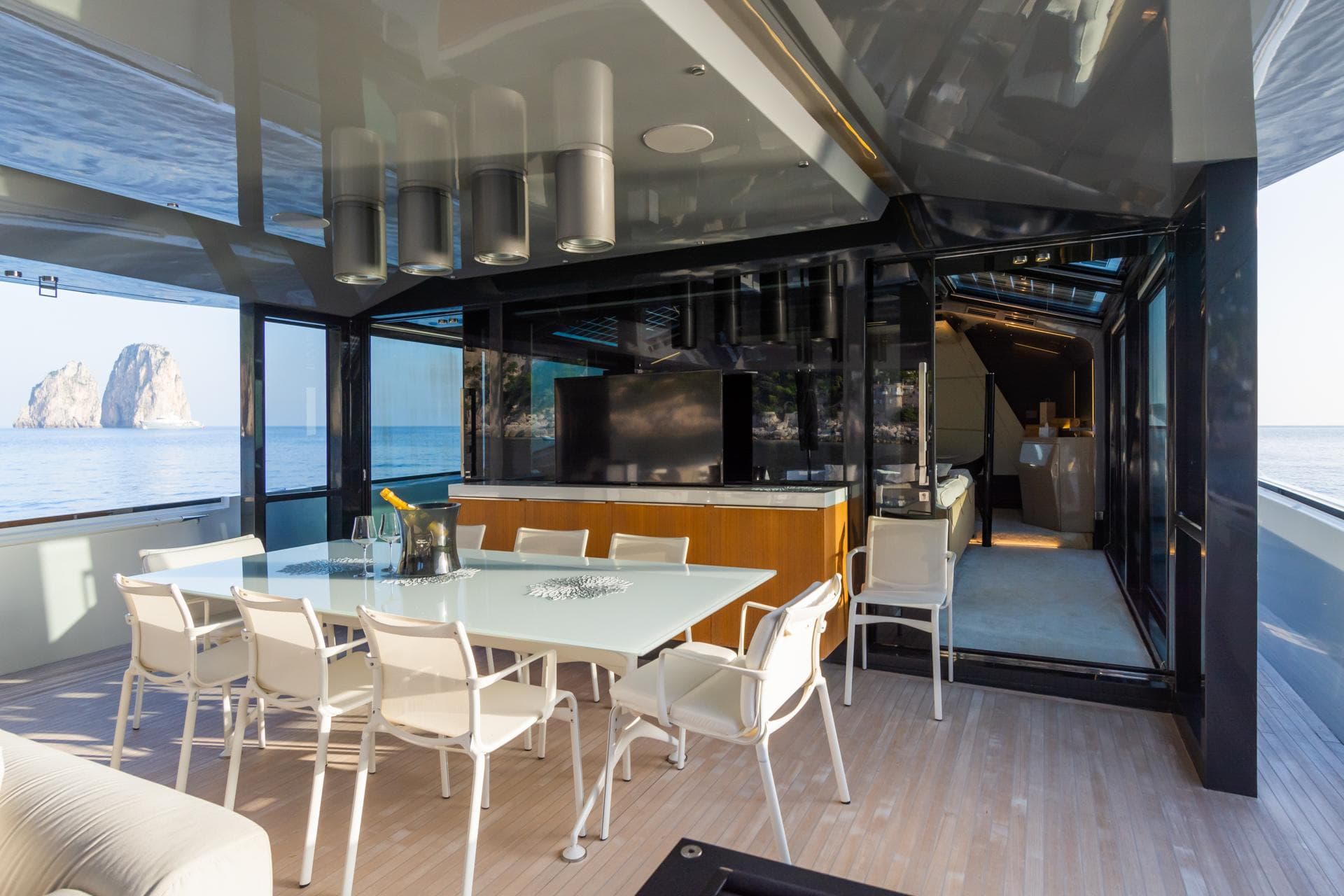Luxurious 2019 Arcadia A85 yacht interior with dining area and ocean view.