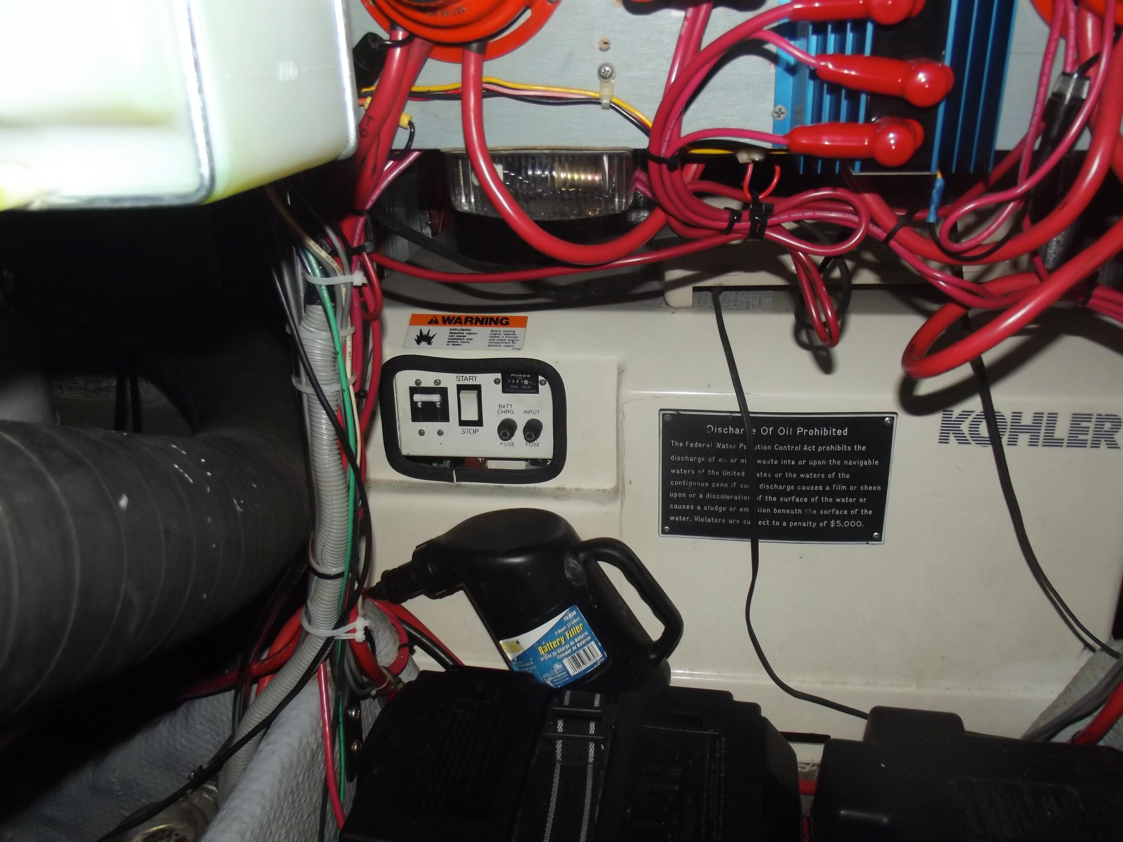 Engine room of 1990 Silverton 37 Convertible with wiring and control panel.