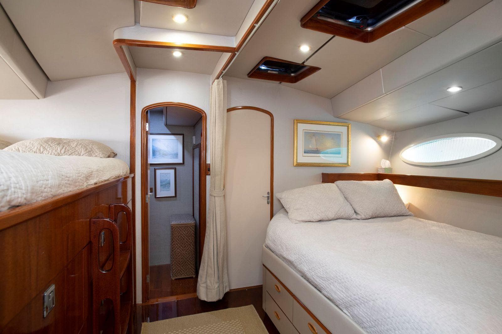 Luxurious cabin interior of 1993 Able Custom 97' yacht with cozy bed and elegant decor.