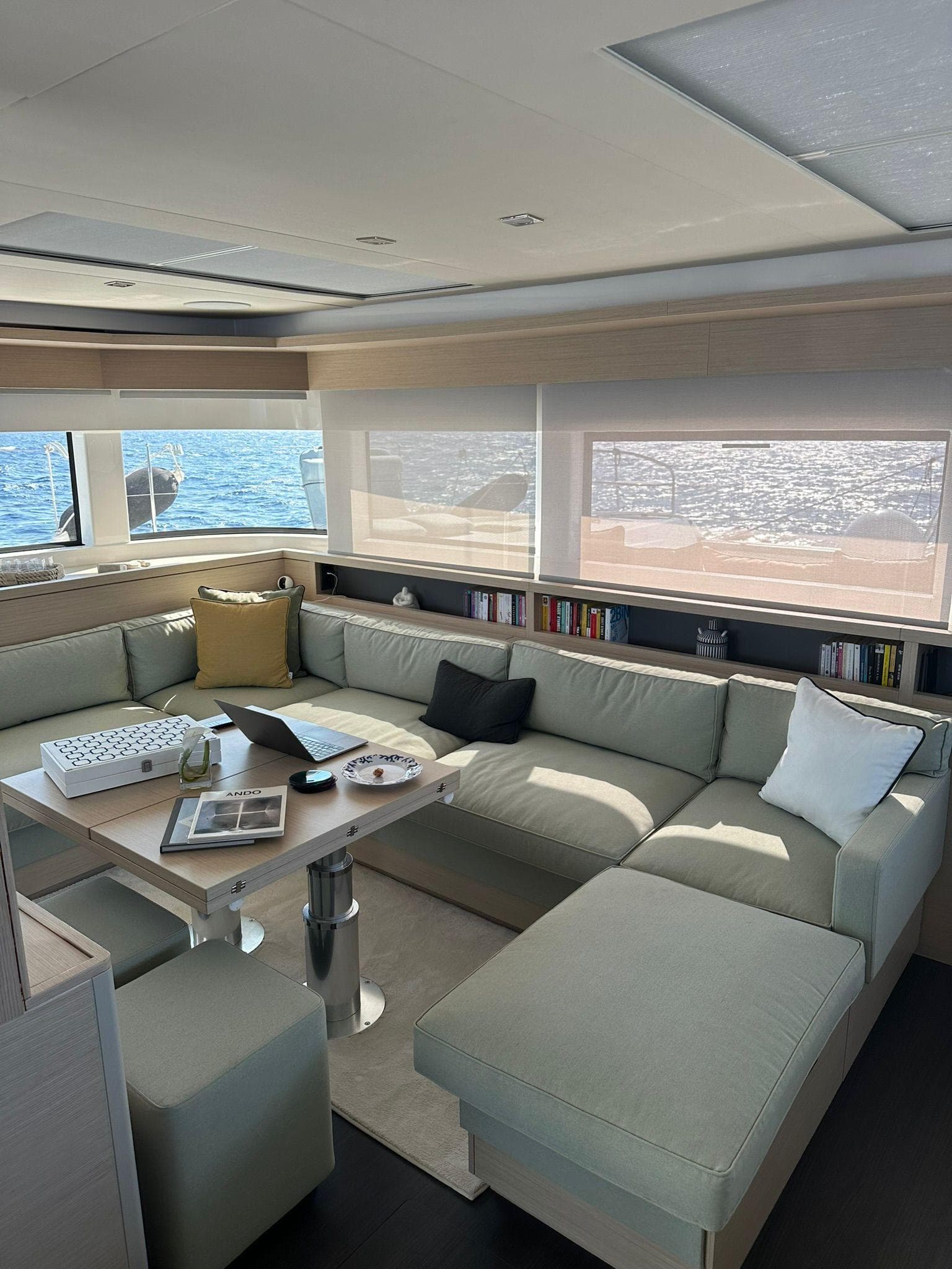 Luxurious interior of 2023 Lagoon 55 yacht with spacious seating and ocean view.