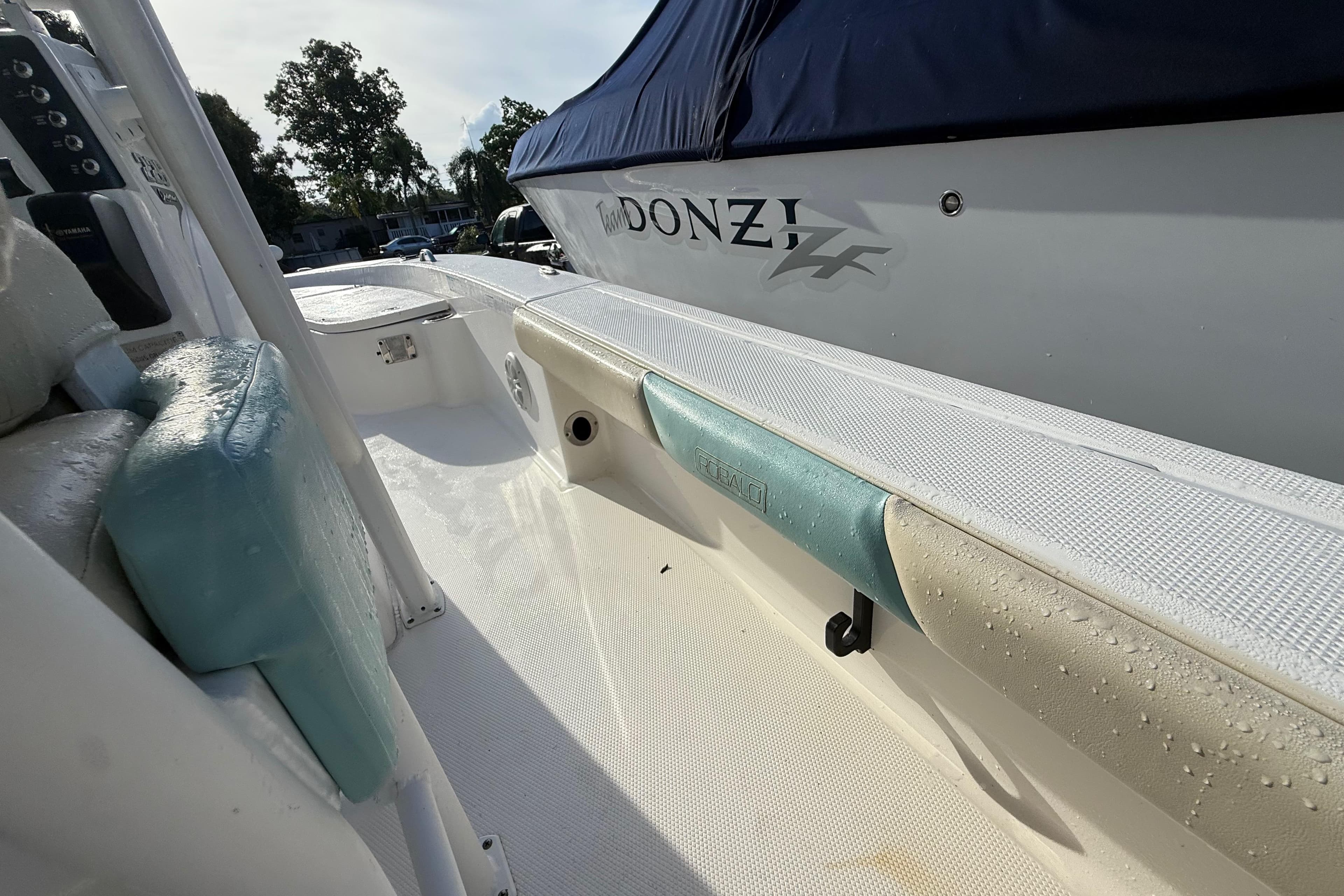 2017 Robalo 226 Cayman boat interior with wet seats and a covered Donzi boat nearby.