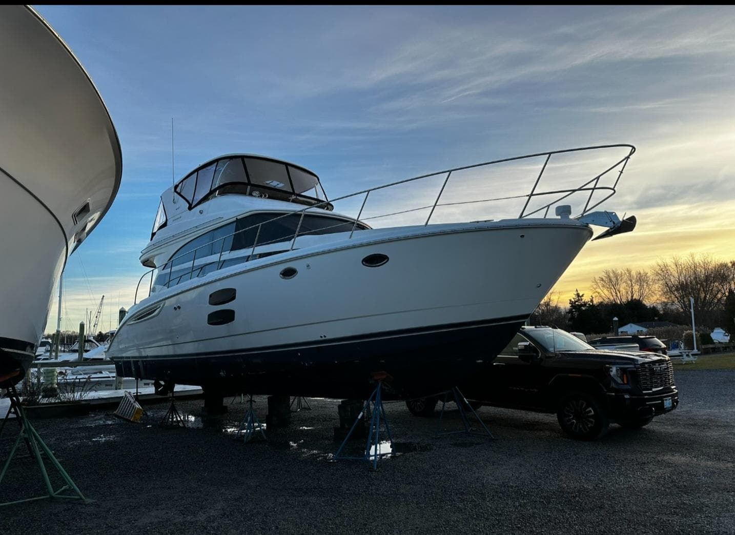 2009 Meridian 441 Sedan yacht on stands at sunset, side view.