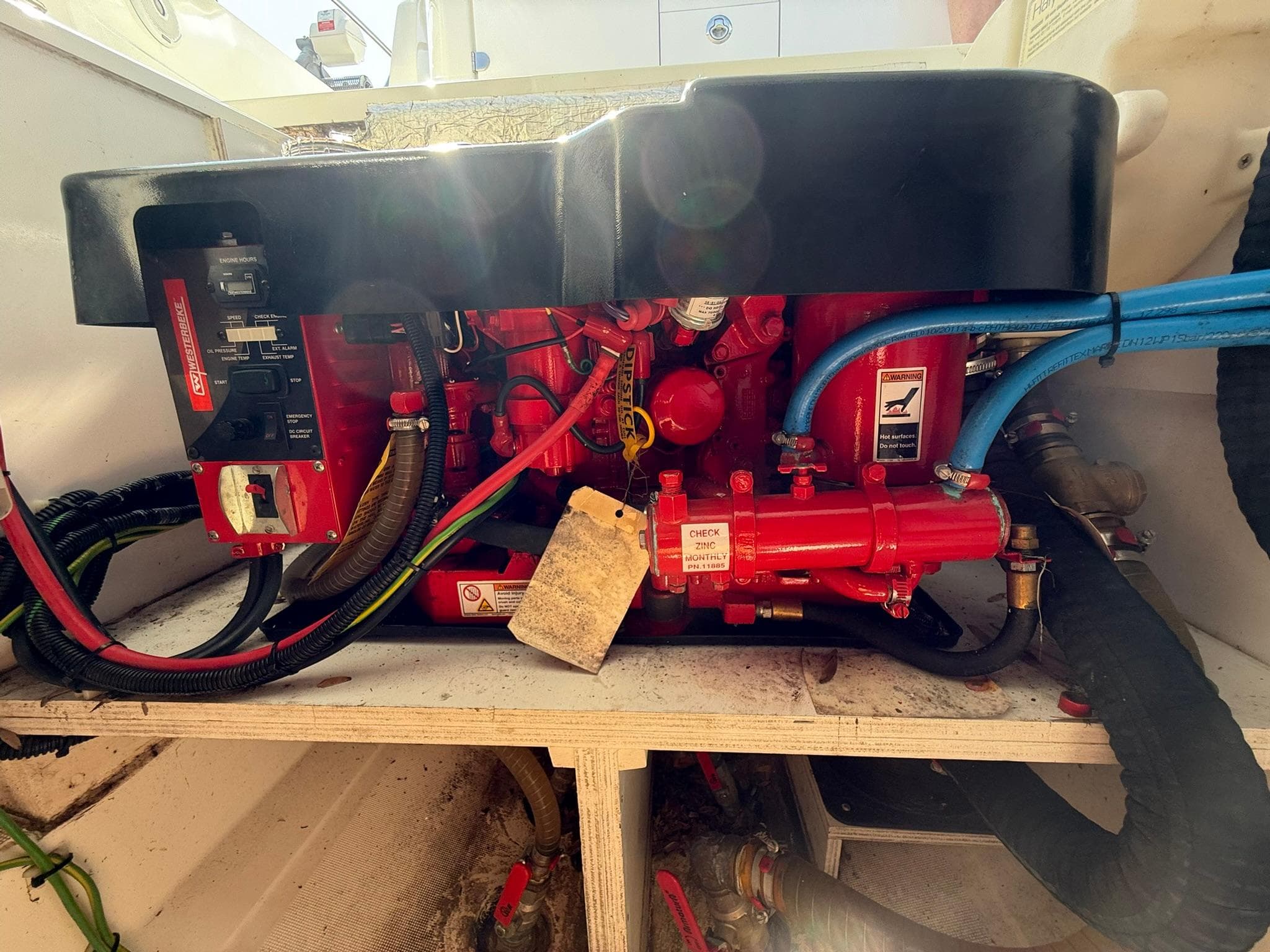 Engine compartment of a 2018 Jeanneau Leader 10.5 boat, featuring red mechanical components.