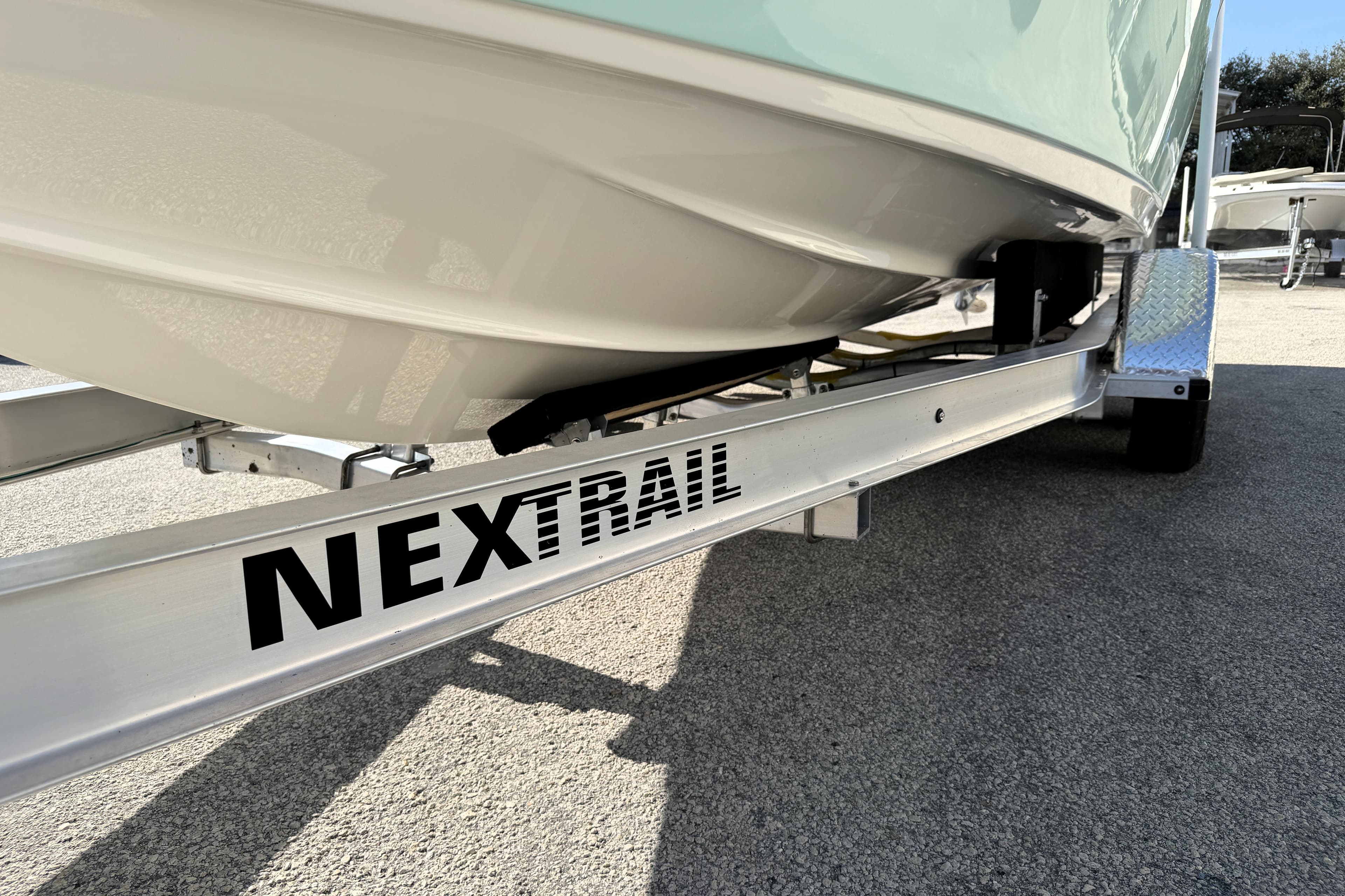 2025 Key West 239 FS boat on NexTrail trailer, close-up view.