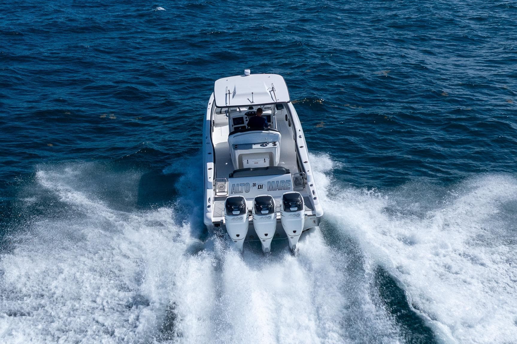 2019 Deep Impact 369 Sport boat cruising on open water, rear view.