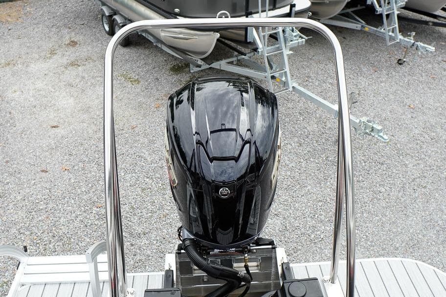 2026 SunCatcher Select 322SL boat engine, sleek black design, parked on gravel.