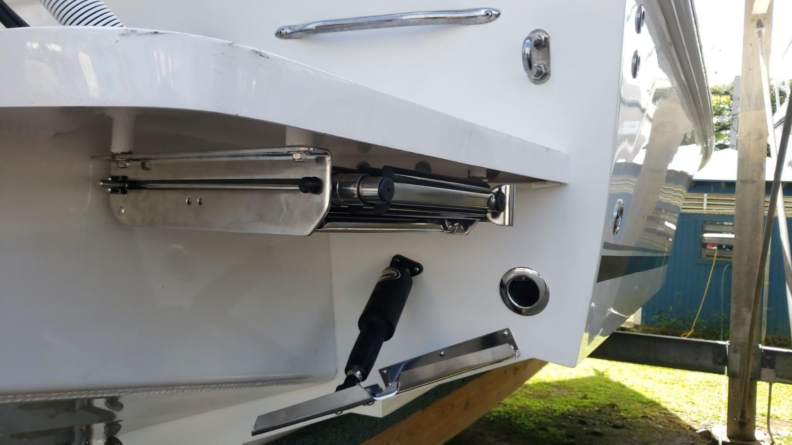 Close-up of 2017 Jupiter 32 Cuddy Cabin boat's trim tab and hydraulic system.