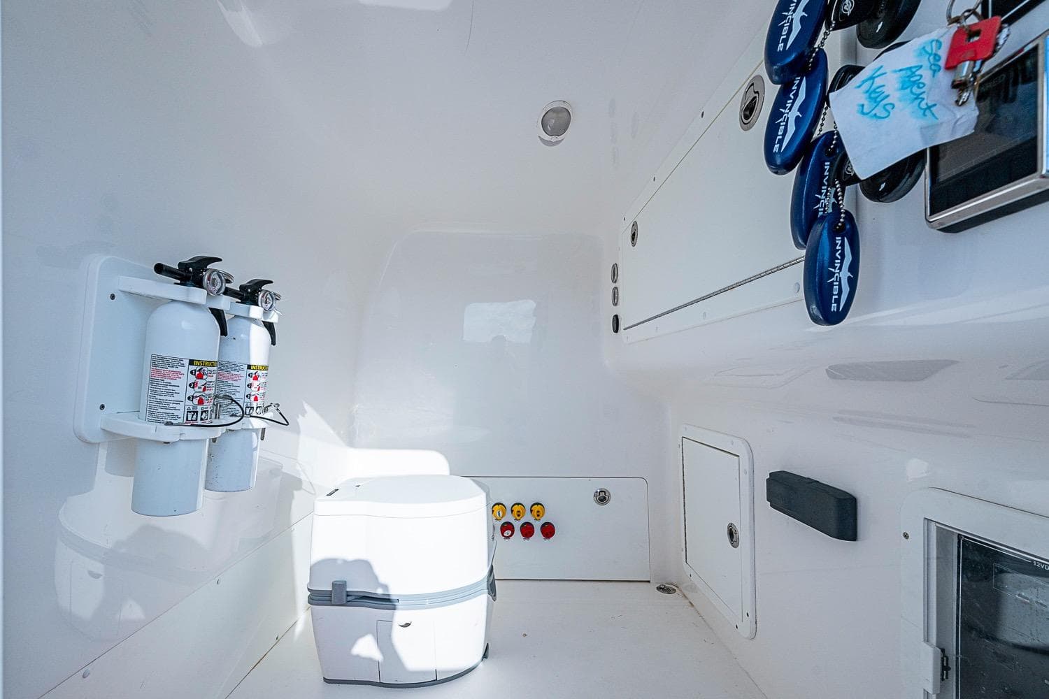 Interior of 2018 Invincible 40 Catamaran featuring fire extinguishers and storage compartments.