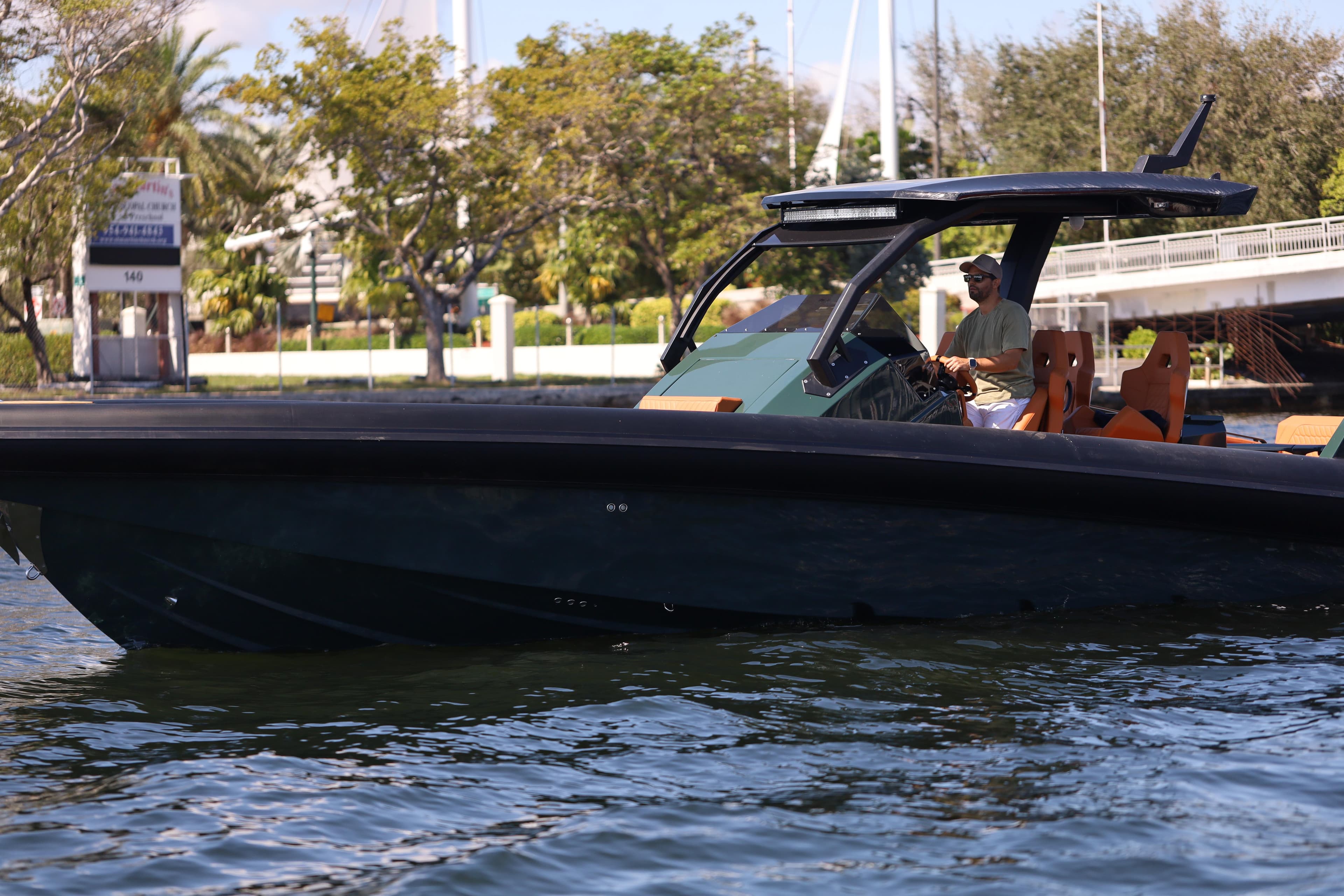 2025 Skipper-BSK 38 boat cruising on a calm waterway, surrounded by lush greenery.