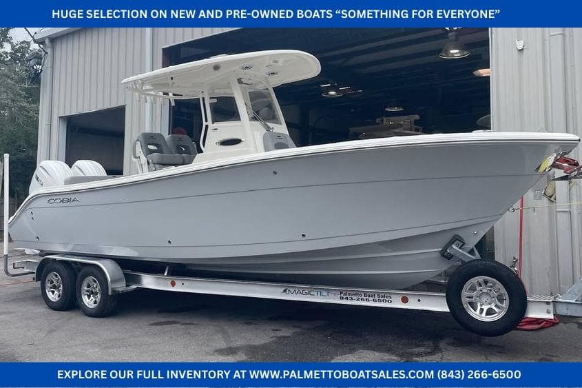 2024 Cobia 262 Center Console boat on trailer outside a warehouse.