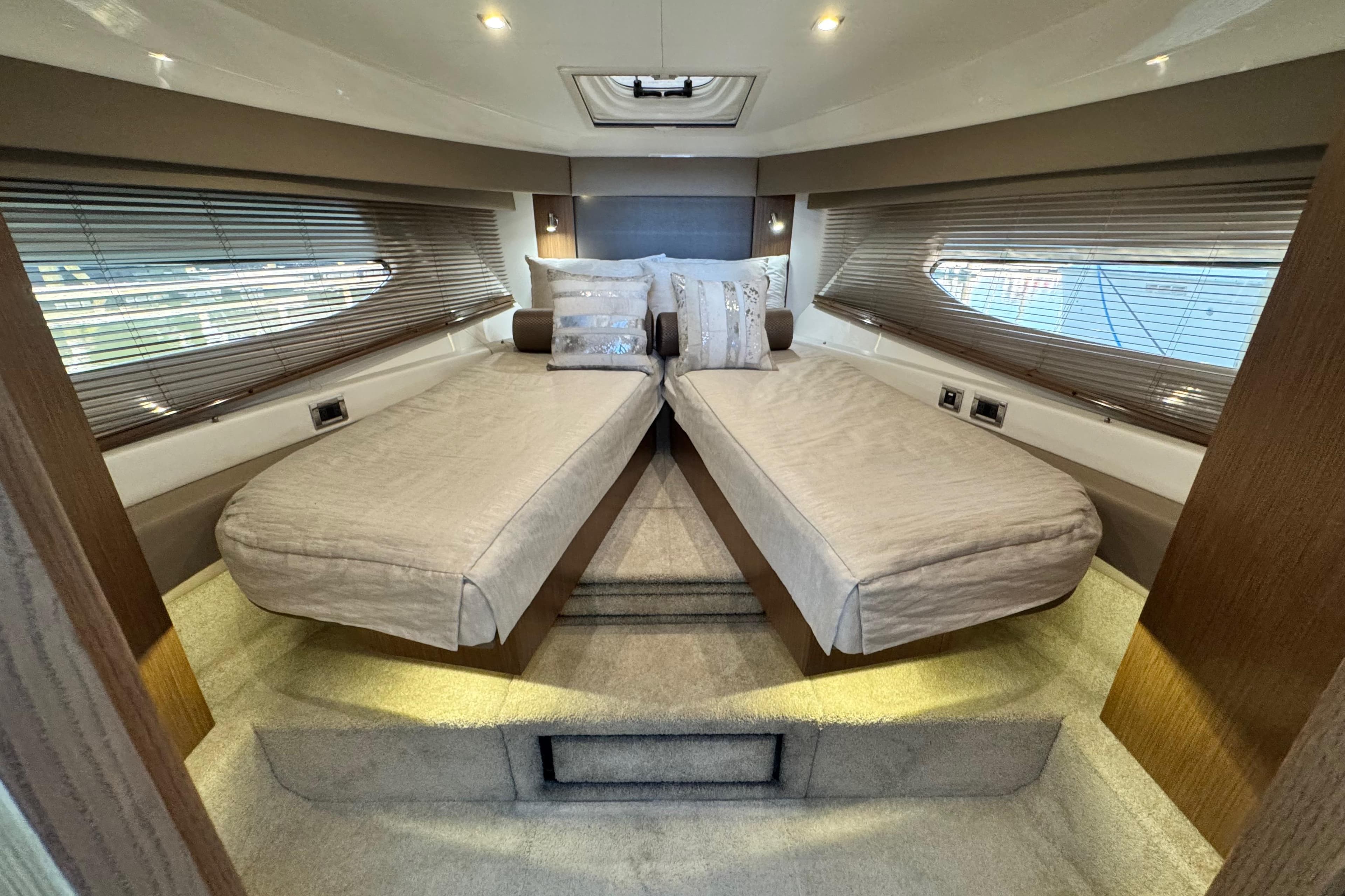 Luxurious interior of 2017 Sea Ray Sundancer 460 yacht with twin beds and elegant decor.