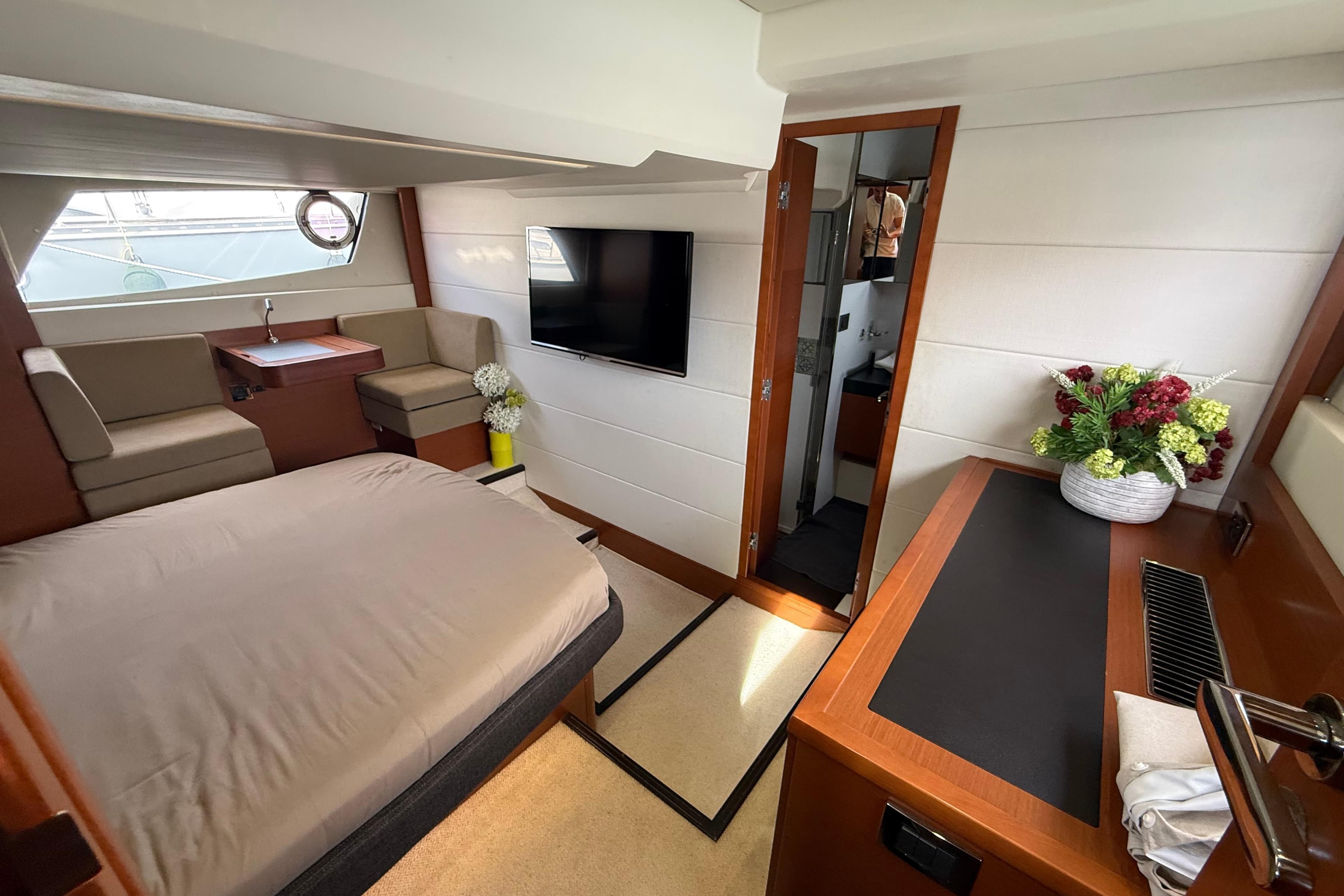 Luxurious interior of 2012 Prestige 500 yacht with bed, seating, and TV.