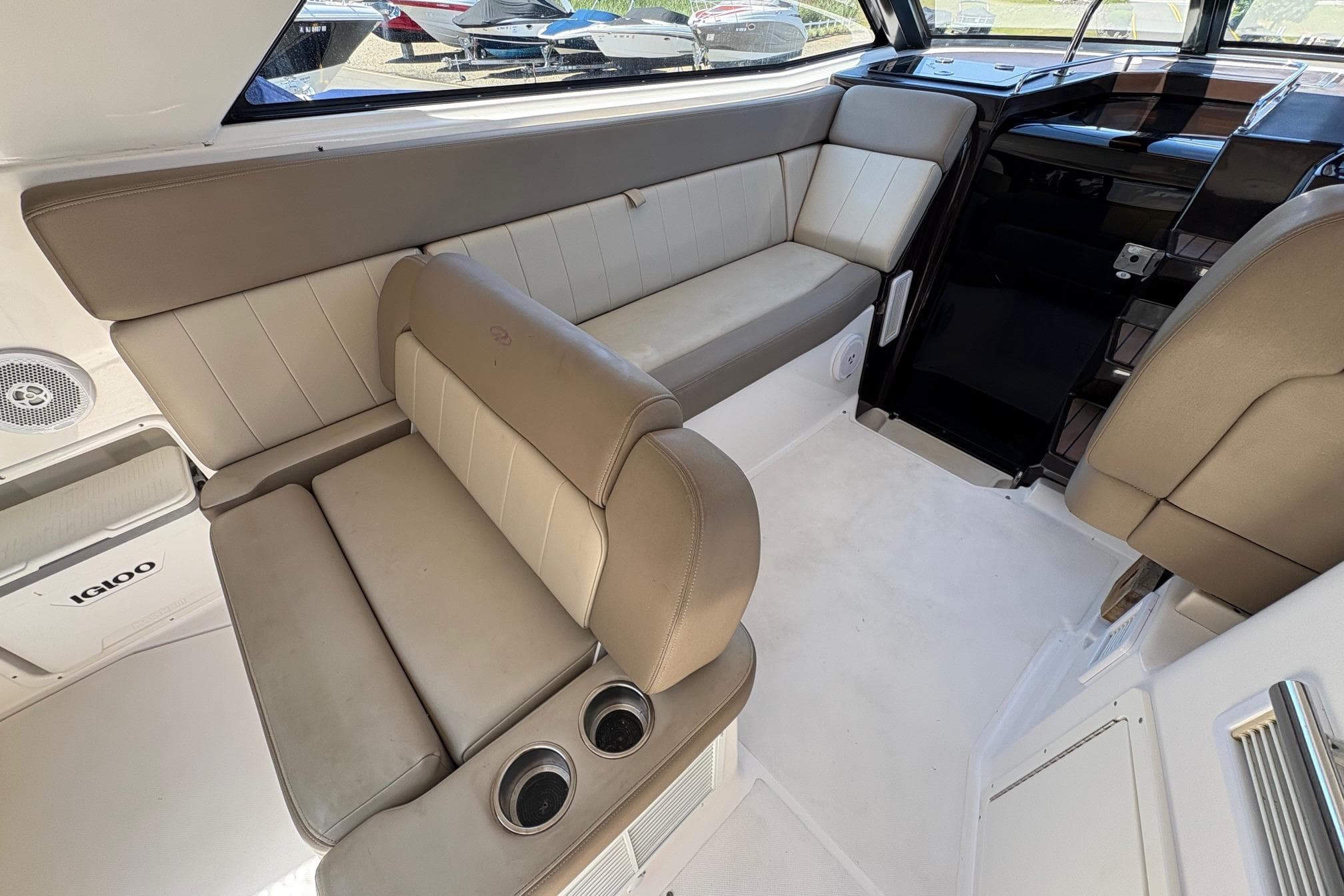 Interior of a 2013 Regal 35 Sport Coupe with beige seating and cup holders.
