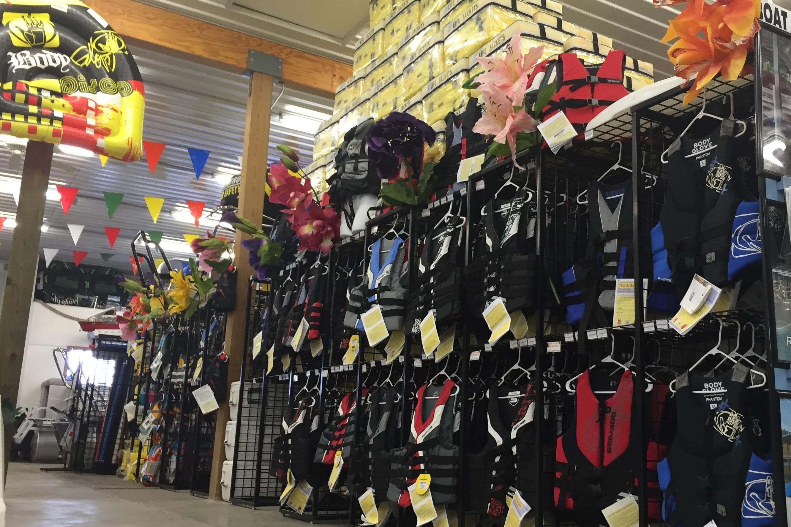Store interior with colorful life jackets and boating accessories on display.