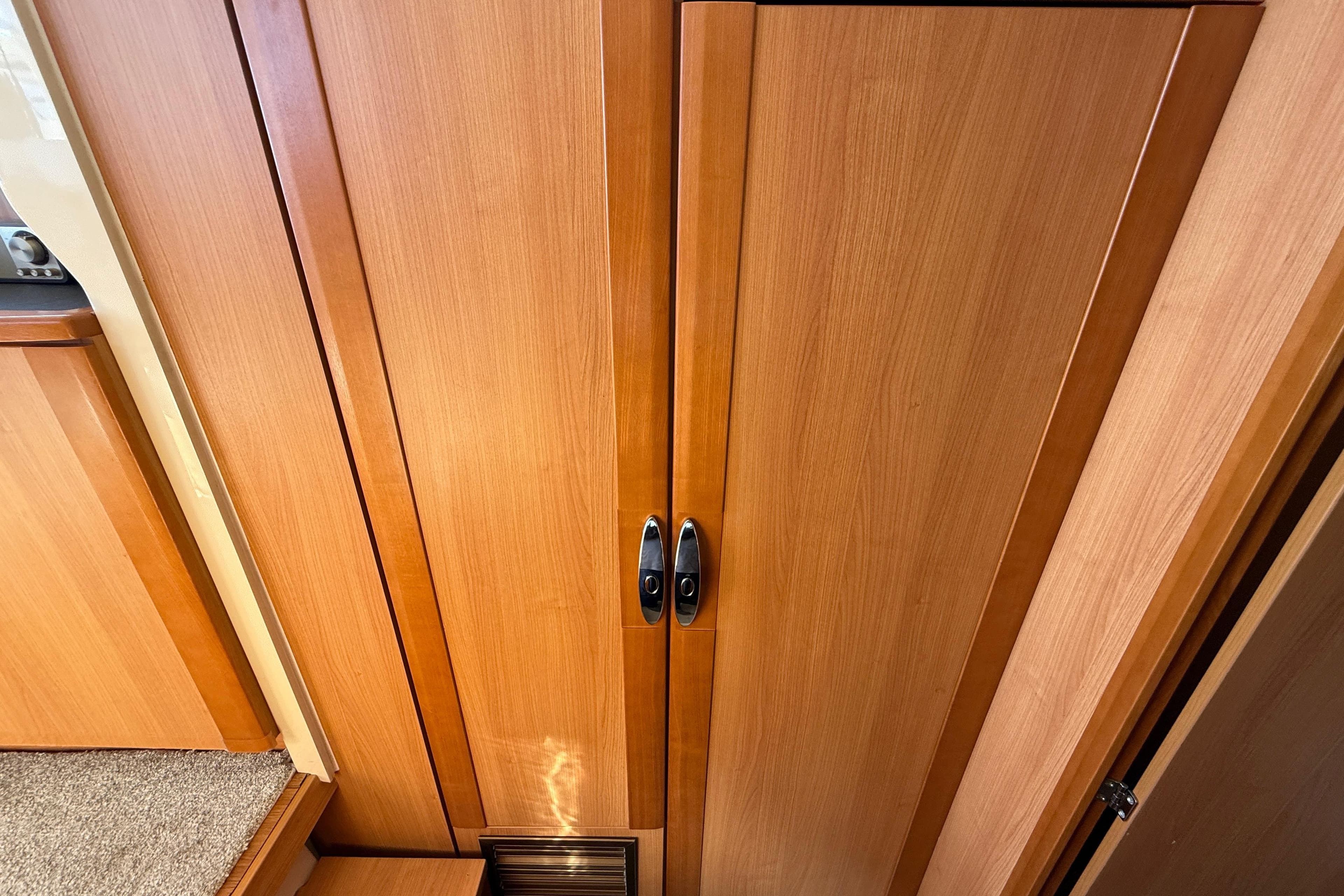 Wooden interior of 2013 Greenline 33 yacht, featuring sleek cabinetry and modern design.