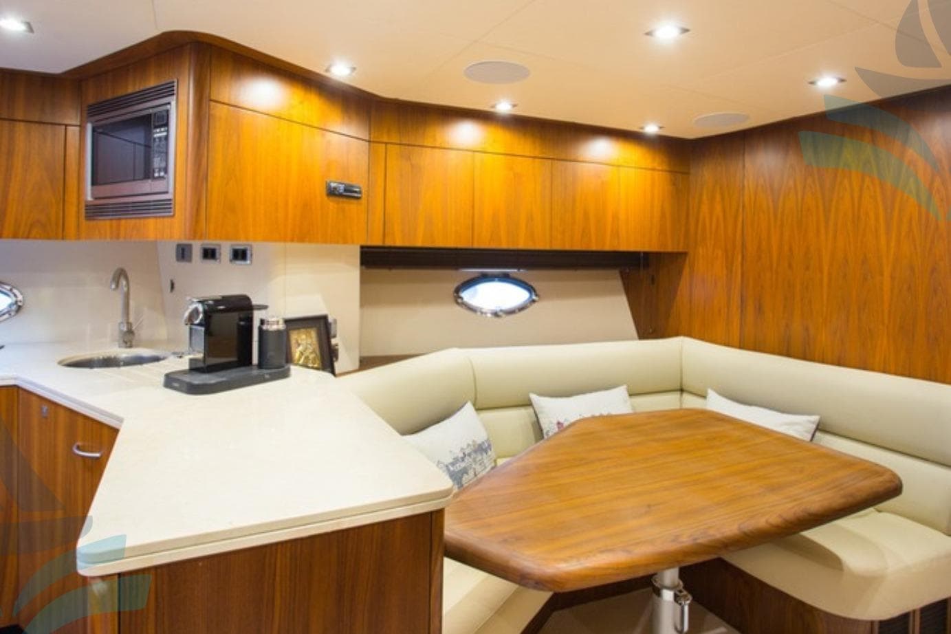 Luxurious interior of 2009 Sunseeker Predator 72 yacht with wood finish and cozy seating area.