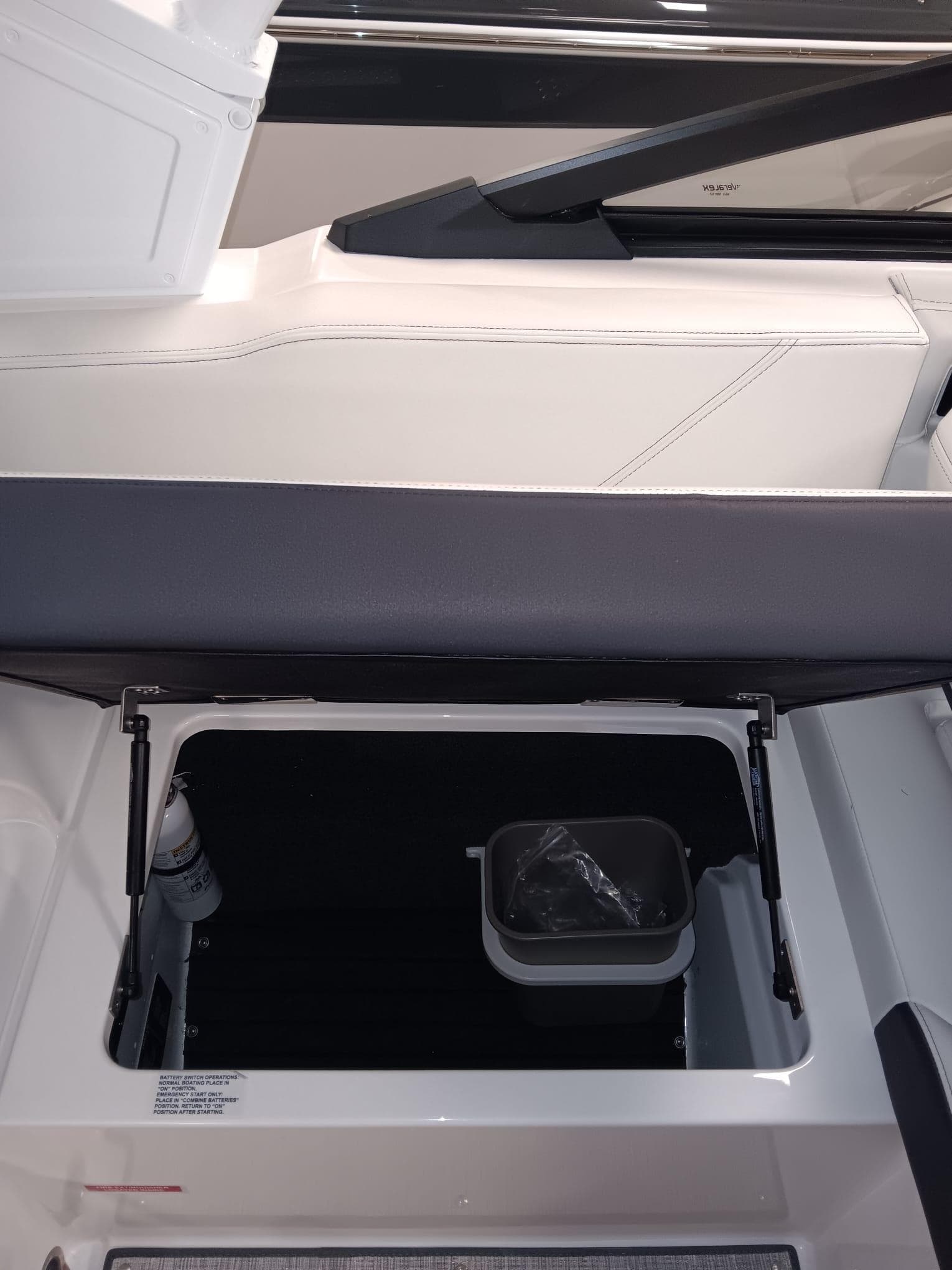 Open storage compartment in 2026 Cobalt R4 boat interior.