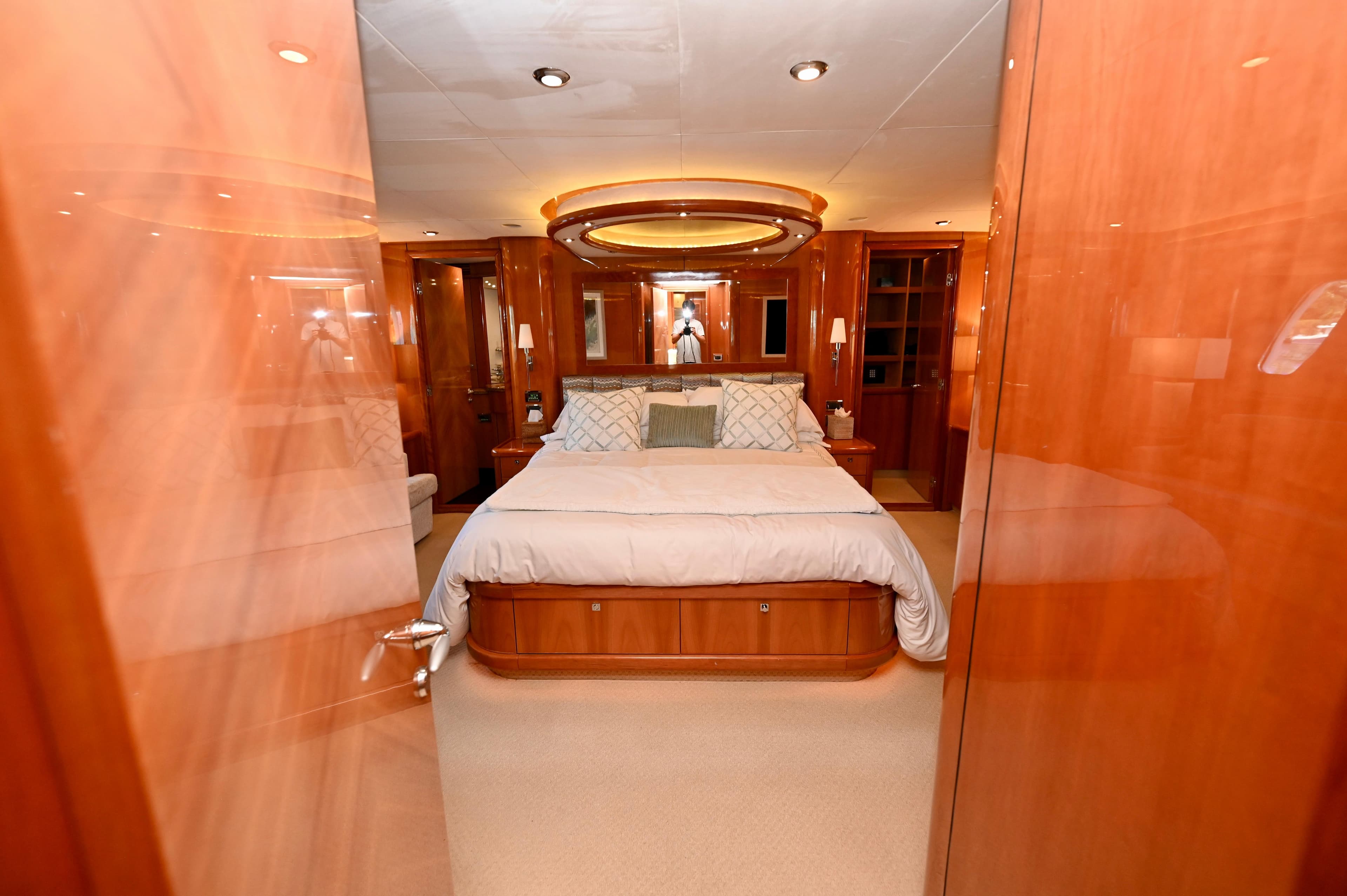 Luxurious bedroom interior of a 2005 Sunseeker 82 Yacht with elegant wood finishes.