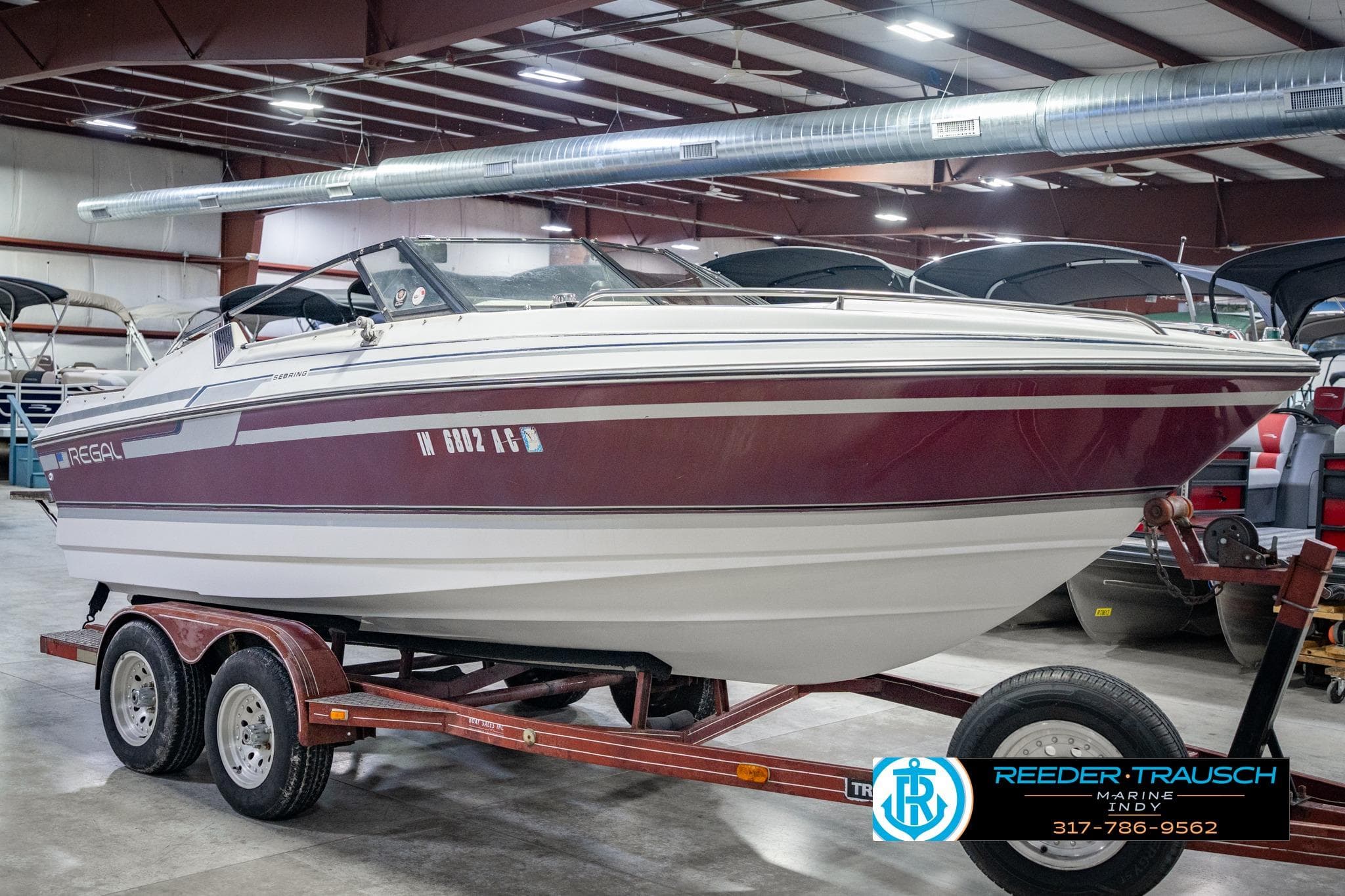 1986 Regal Sebring 195 boat on trailer in indoor showroom, Reeder Trausch Marine.